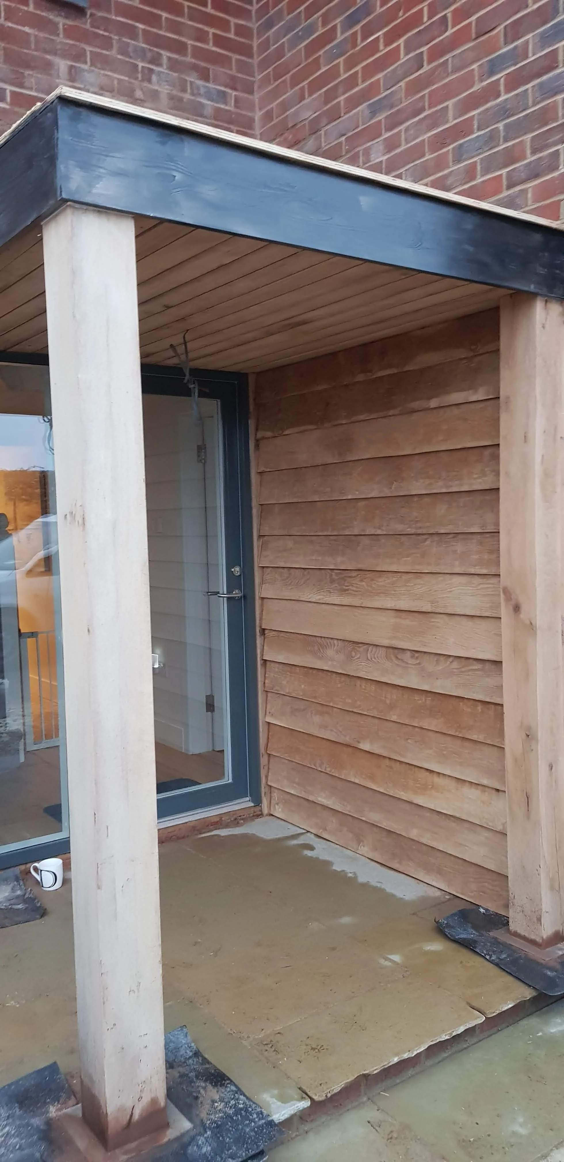 Small oak post porch with oak cladding