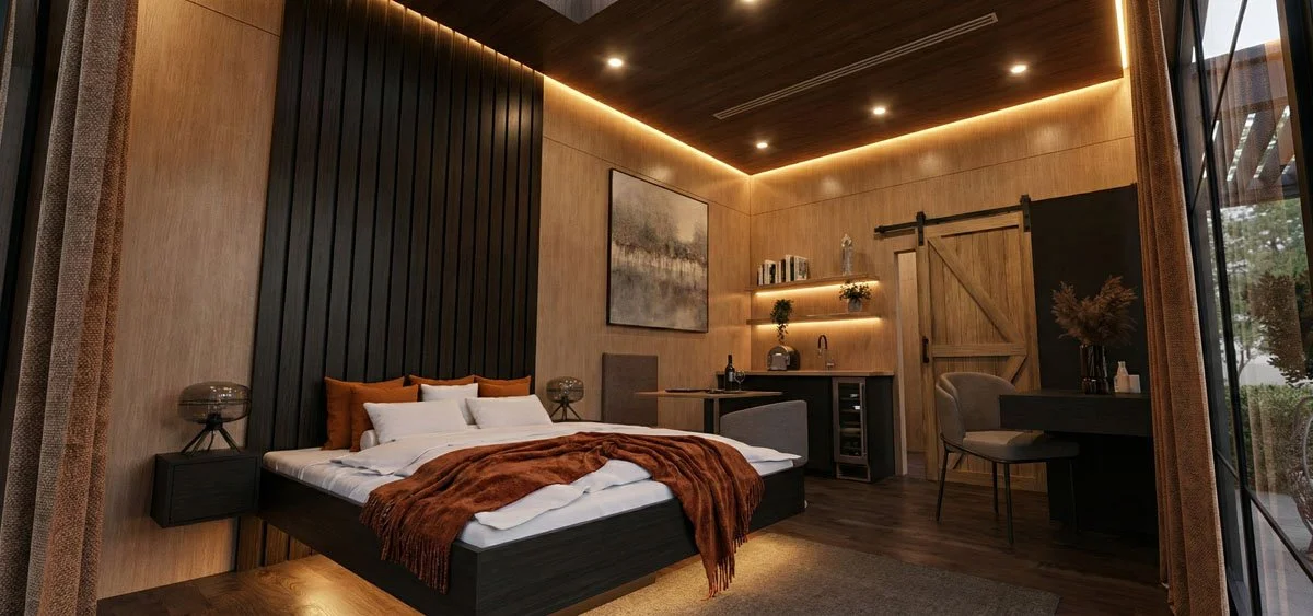 Modern bedroom with a dark wood bed frame and rust-colored throw blanket, beige paneled walls, a built-in kitchenette area, and a sliding barn door.