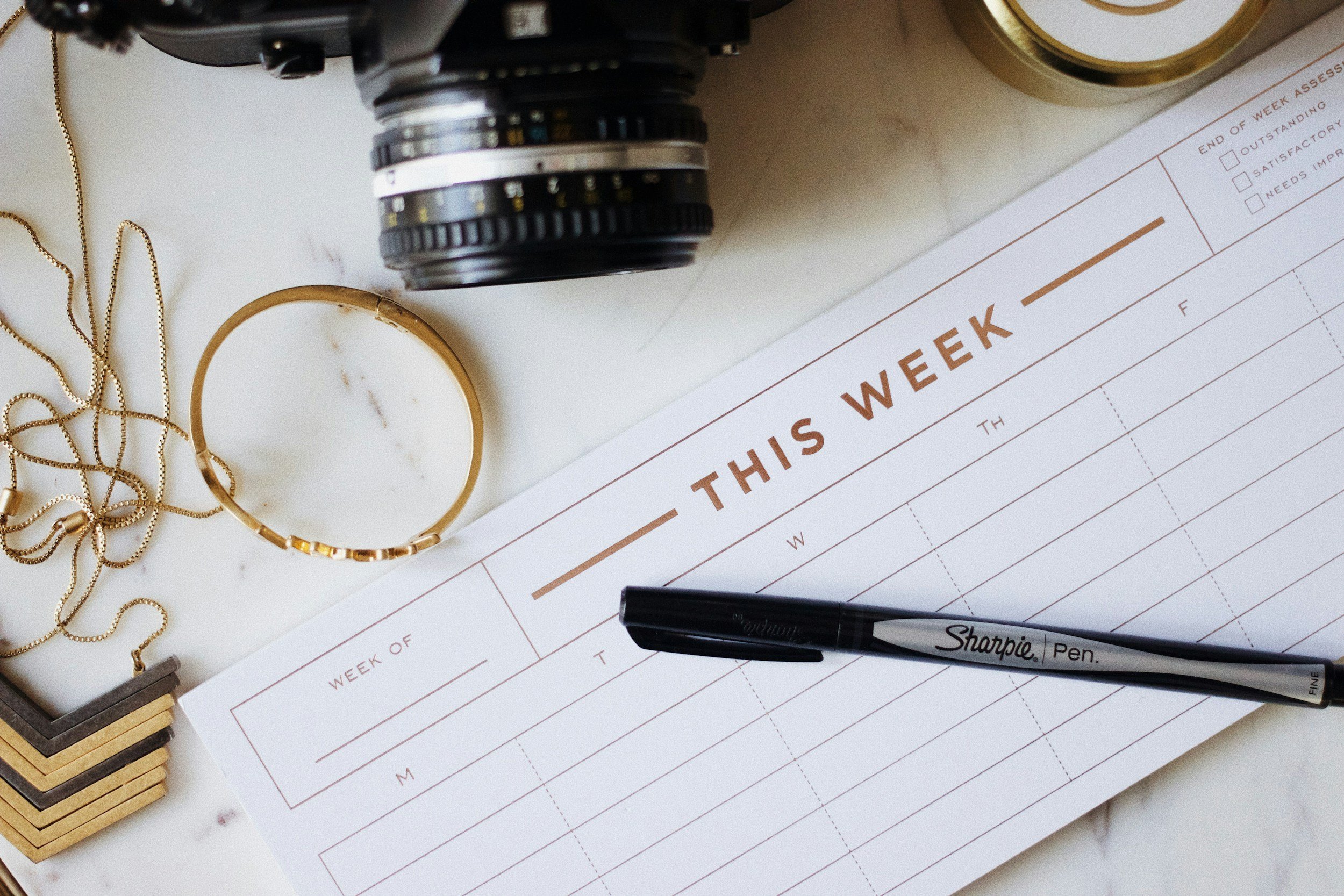 Business planner and camera equipment for Florida wedding photography financial planning