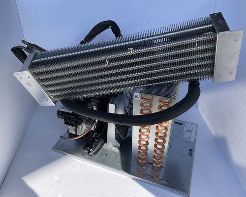 A computer CPU cooler with a large aluminum heatsink and copper heat pipes, mounted on a metal base with wiring.