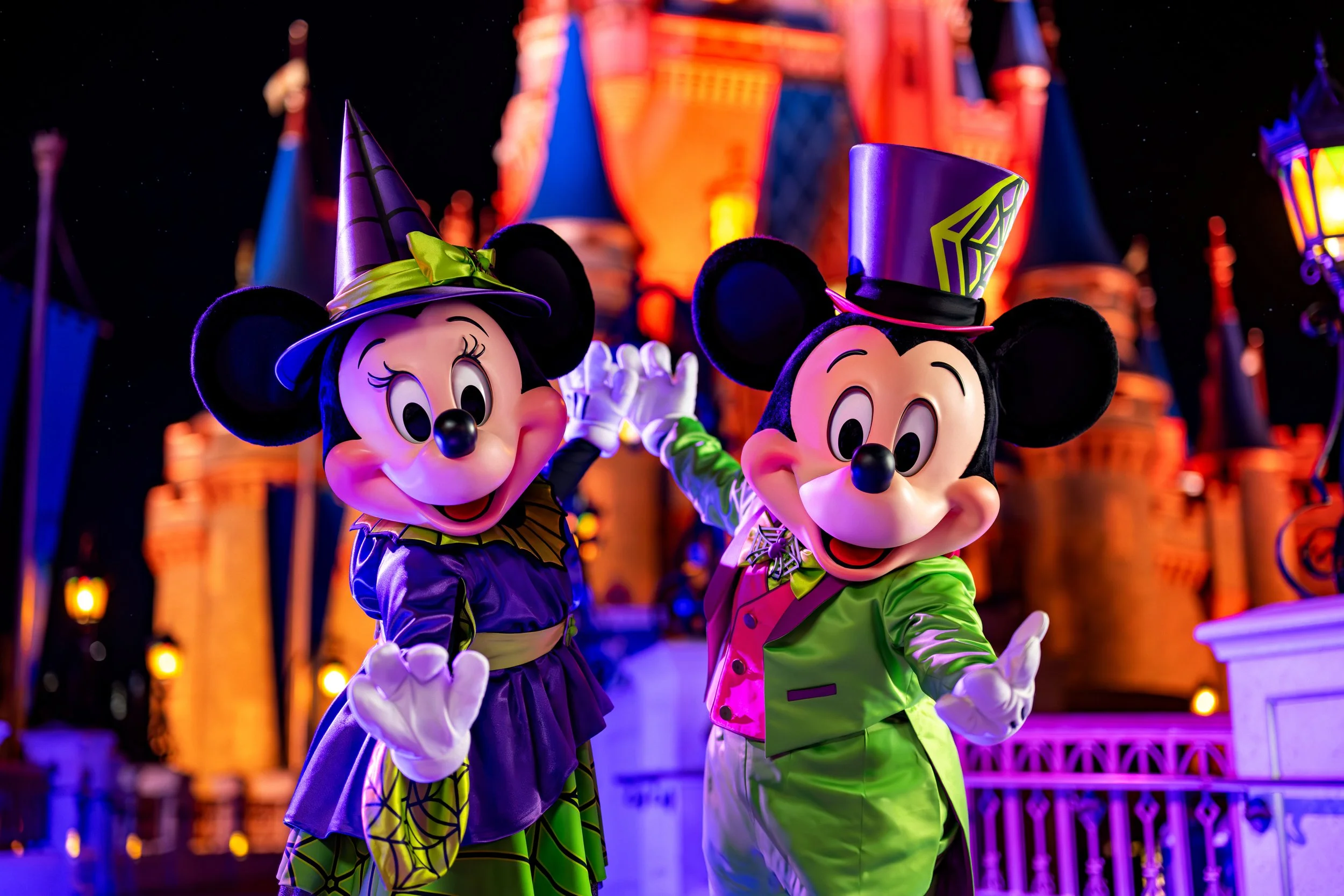 Minnie Mouse and Mickey Mouse dressed in Halloween costumes at Disneyland.