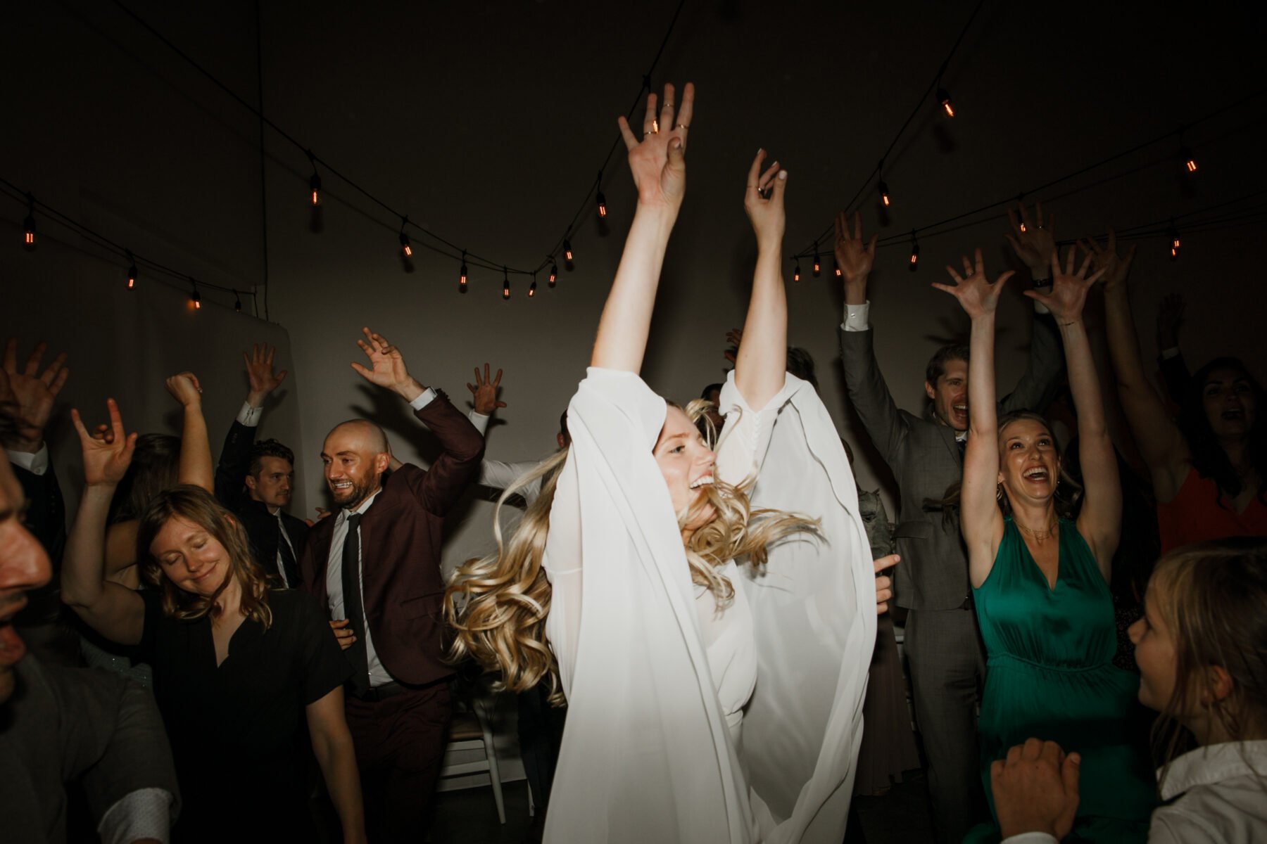 Wedding guest dancing with their arms raised inside a Toronto event venue and spacious studio 