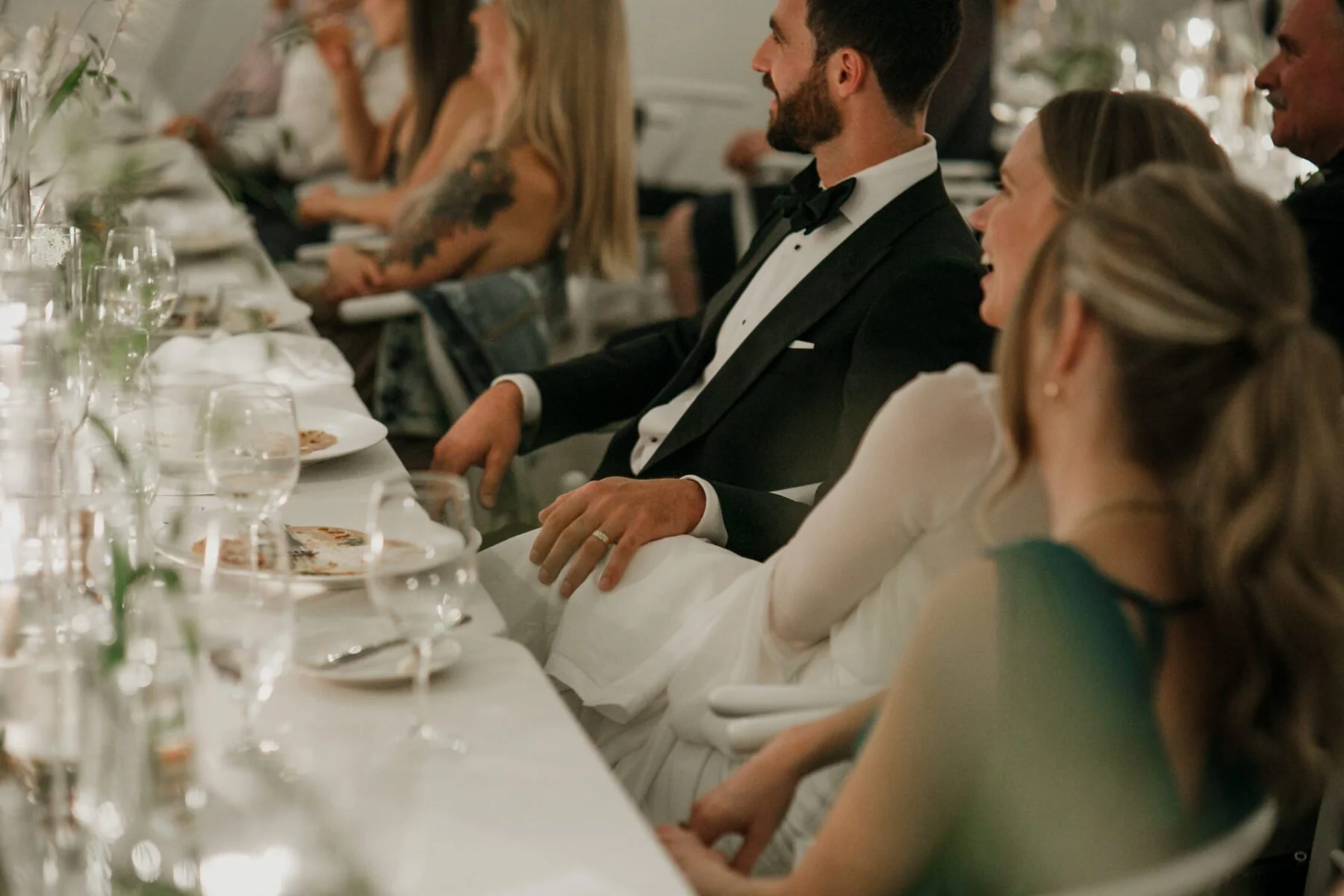 Bride and groom smiling with their wedding guests