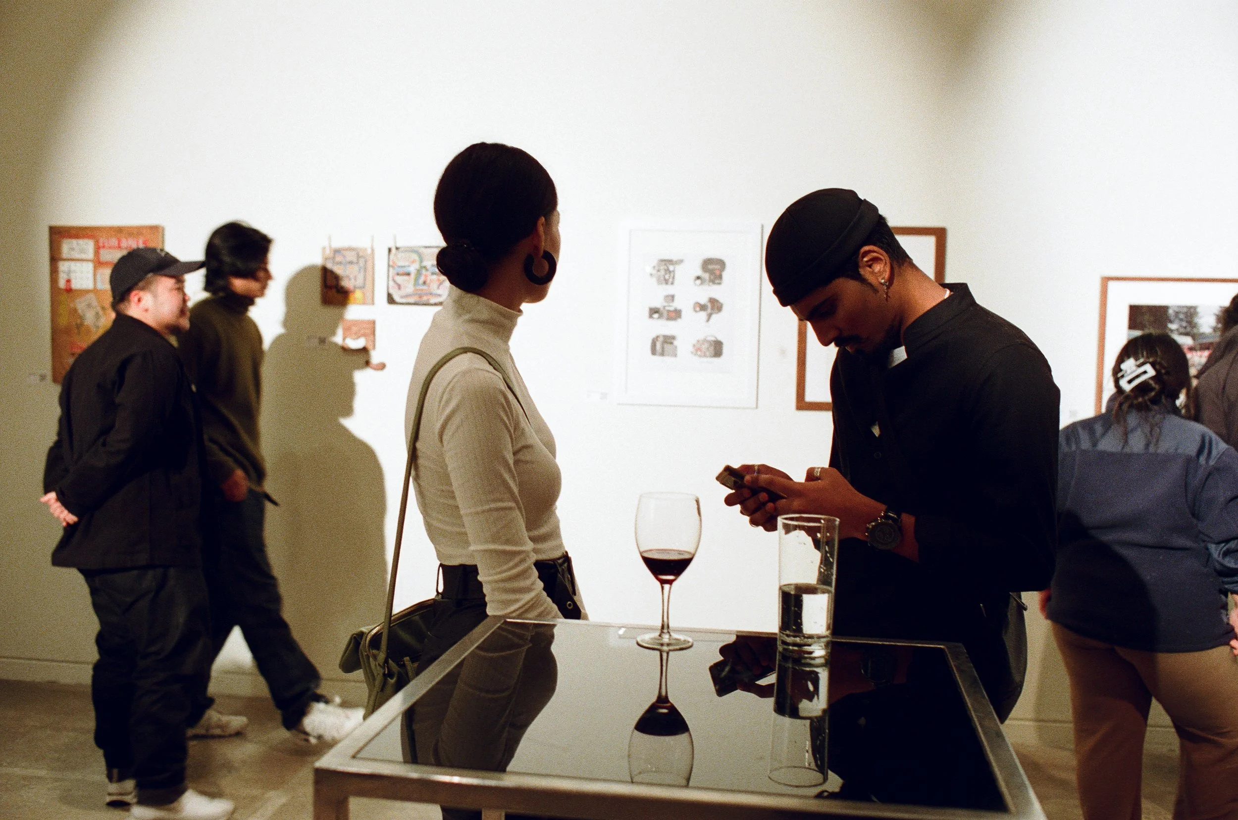People mingling and looking at art during a gallery exhibition inside a Toronto studio rental space and event venue.