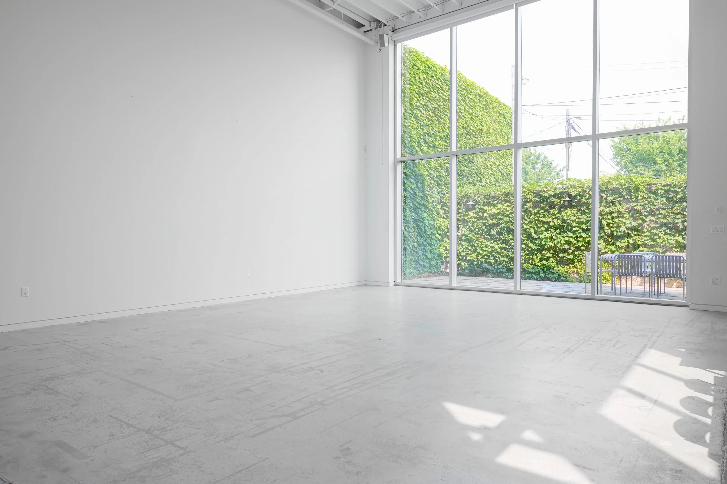 View of Studio A's private outdoor patio and 18 ft by 18 ft floor to ceiling windows
