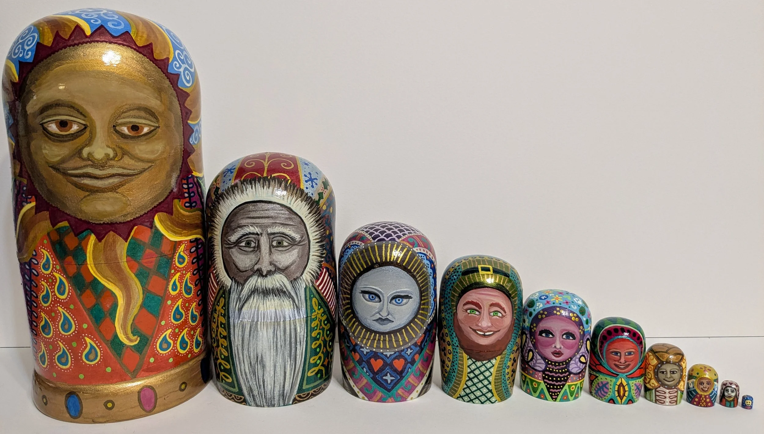 "Pagan Wheel of the Year, personified" themed Russian nesting dolls.
India ink on wooden blank dolls.
2025. 