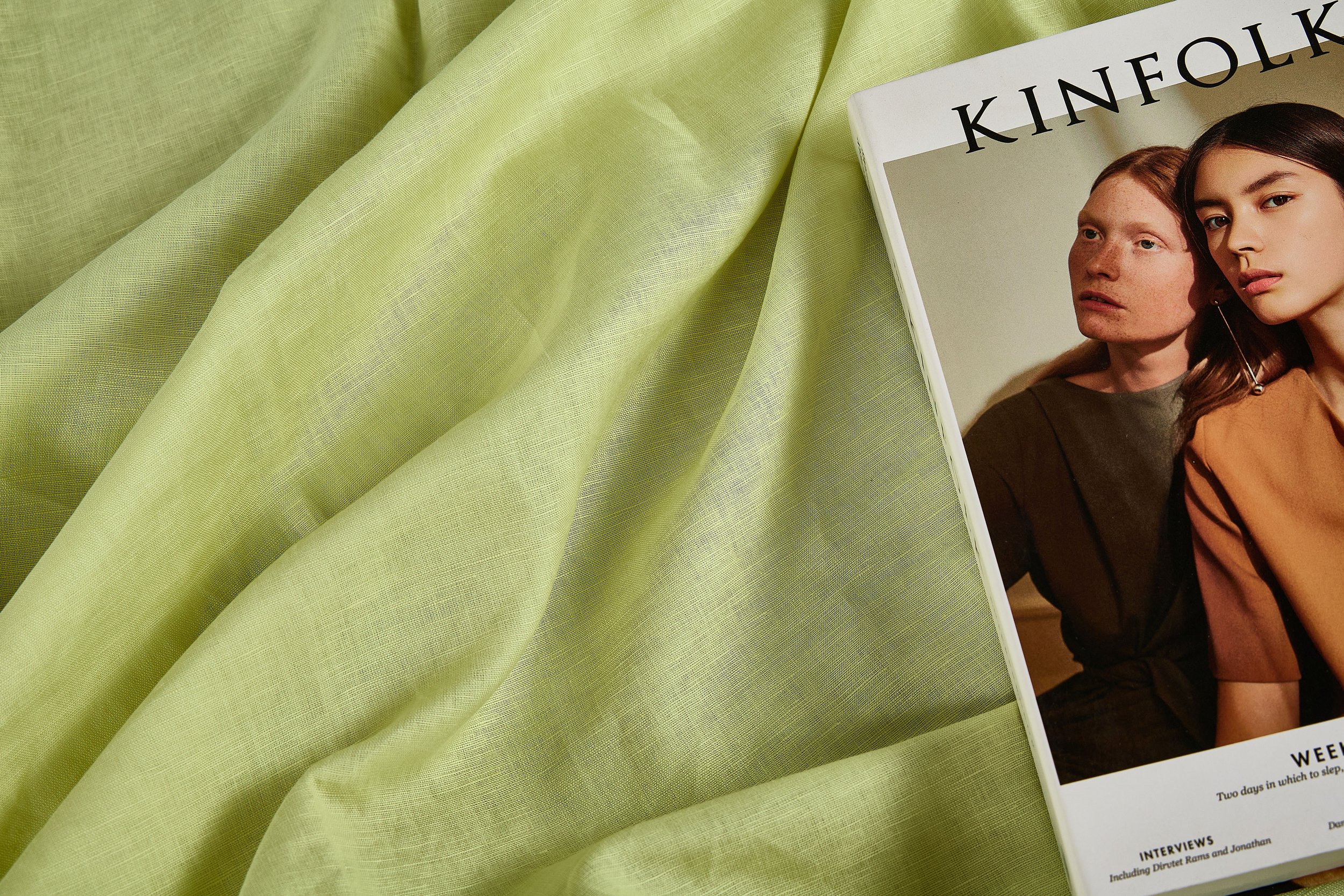 55% linen 45% cotton fabric naturally draped over an oak beam showing organic drape, wrinkle recovery, and raw selvedge edge.