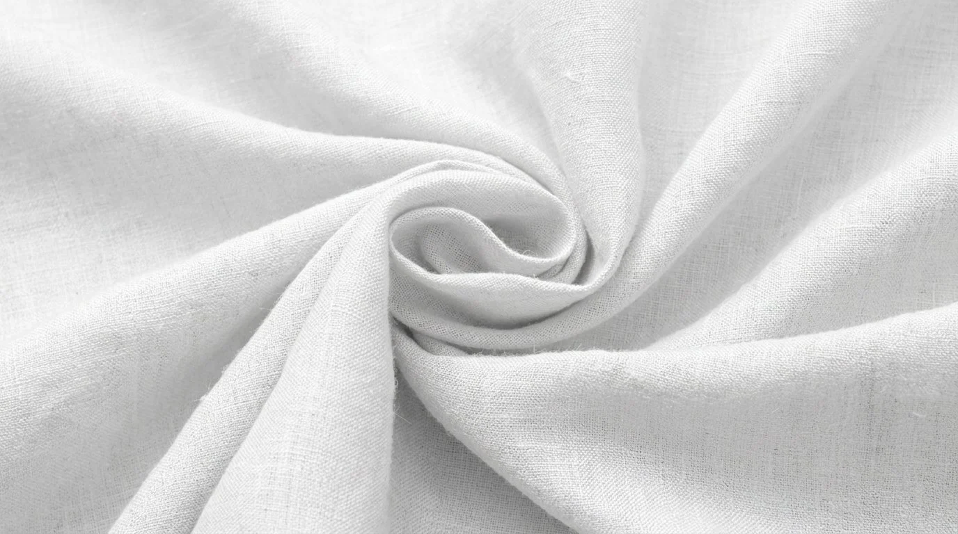 Close up detail of bleached white 100% pure linen fabric rosette showing fine yarn density and breathable weave