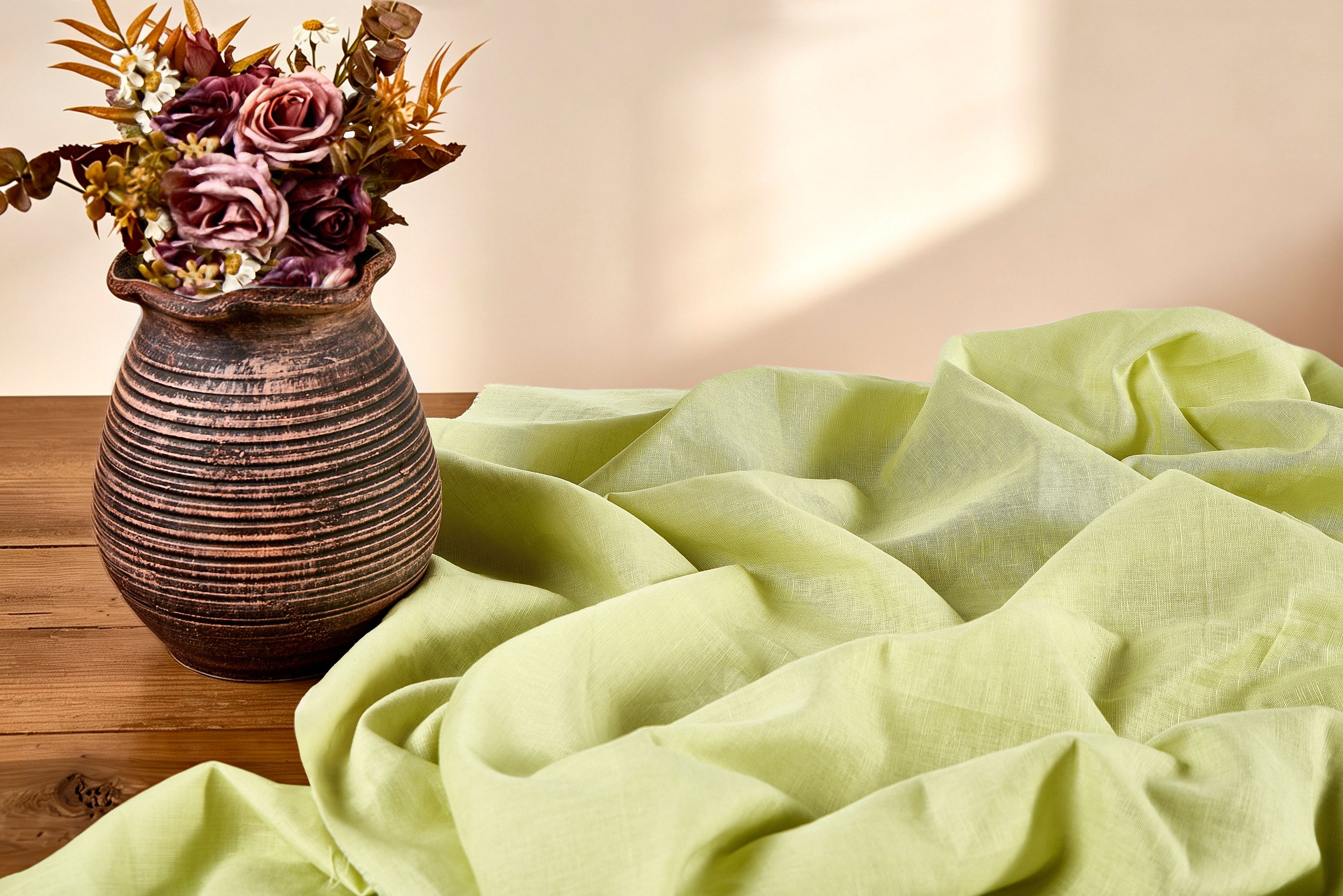 Lightweight pale green cotton linen blended fabric with soft folds, wholesale breathable summer apparel fabric from China exporter.