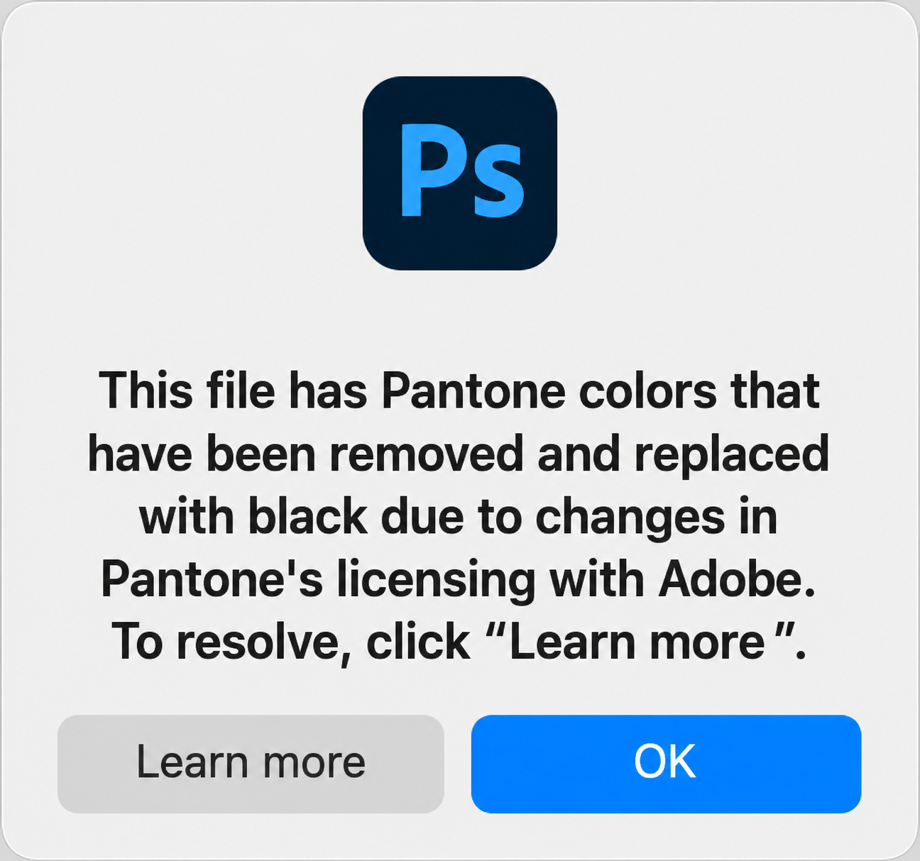 An Adobe Photoshop error message indicating the file has Pantone colors replaced with black due to licensing changes, with options to learn more or click OK.