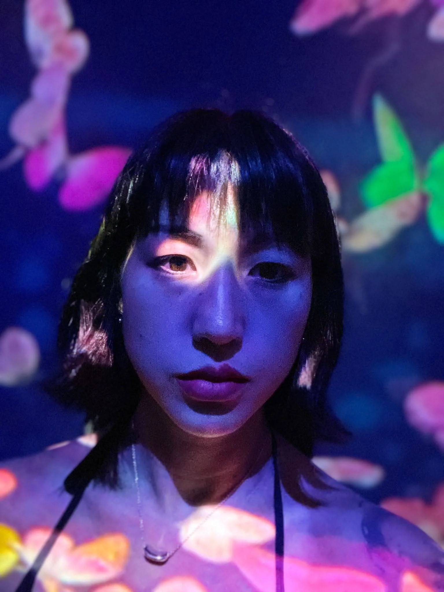 Headshot of Lida in a purple lit space