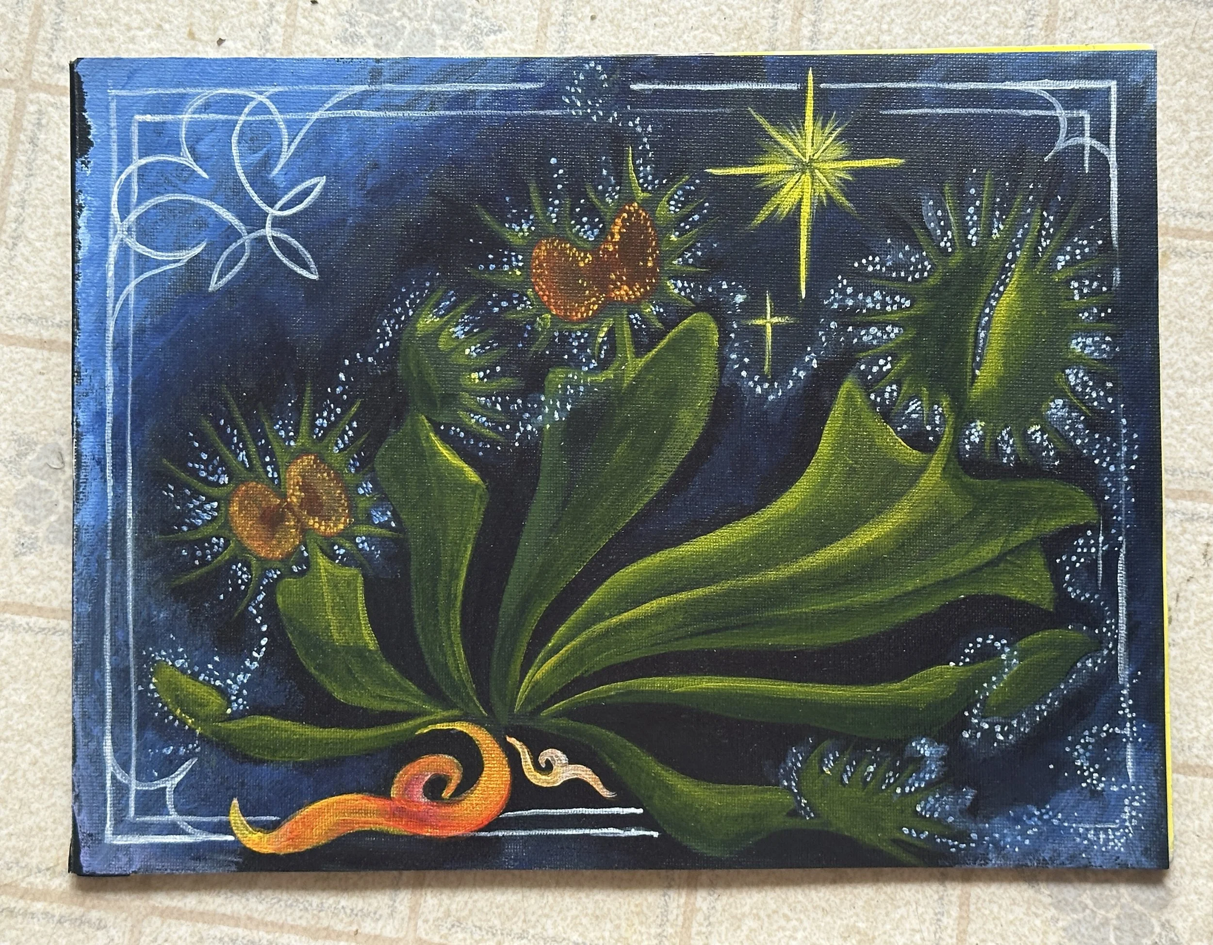 Close-up of a painted artwork featuring a dark background with bright, colorful celestial and botanical motifs, including stars, sparkles, and green leaves.