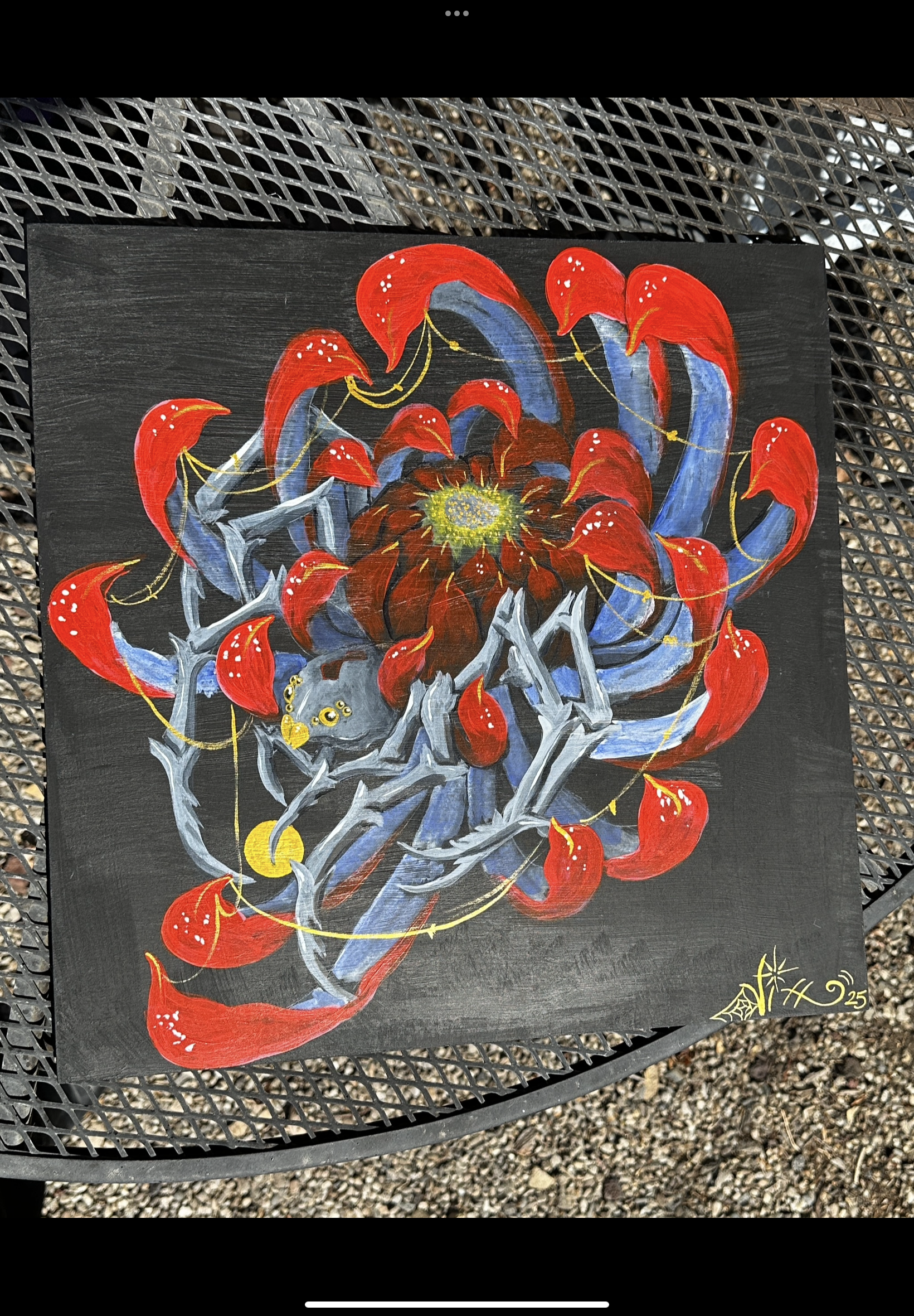 Painting featuring red, blue, and black abstract floral designs on a black background, signed with the year 2023 in the bottom right corner.