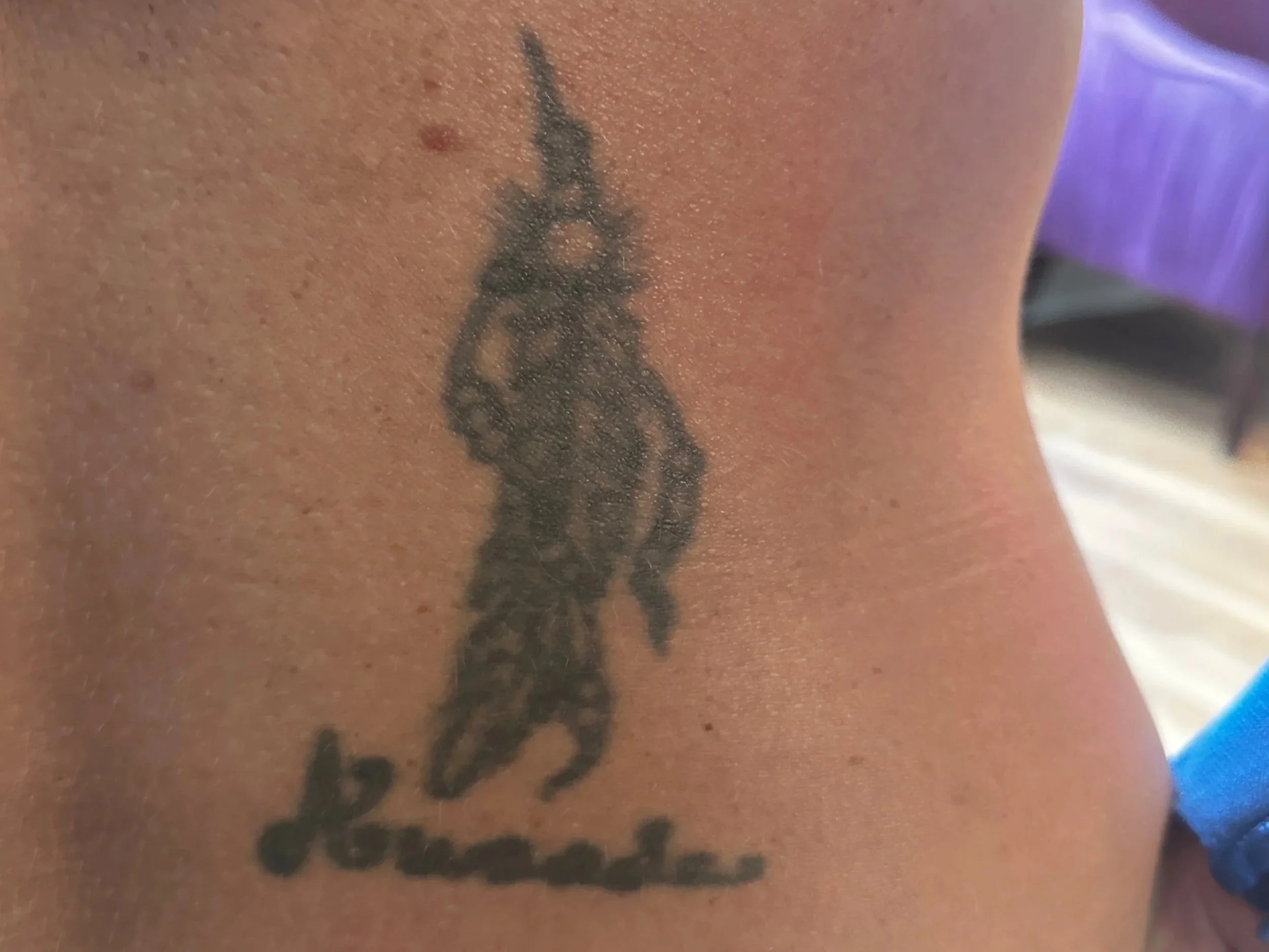 Close-up of a tattoo of the Eiffel Tower on a person's skin.