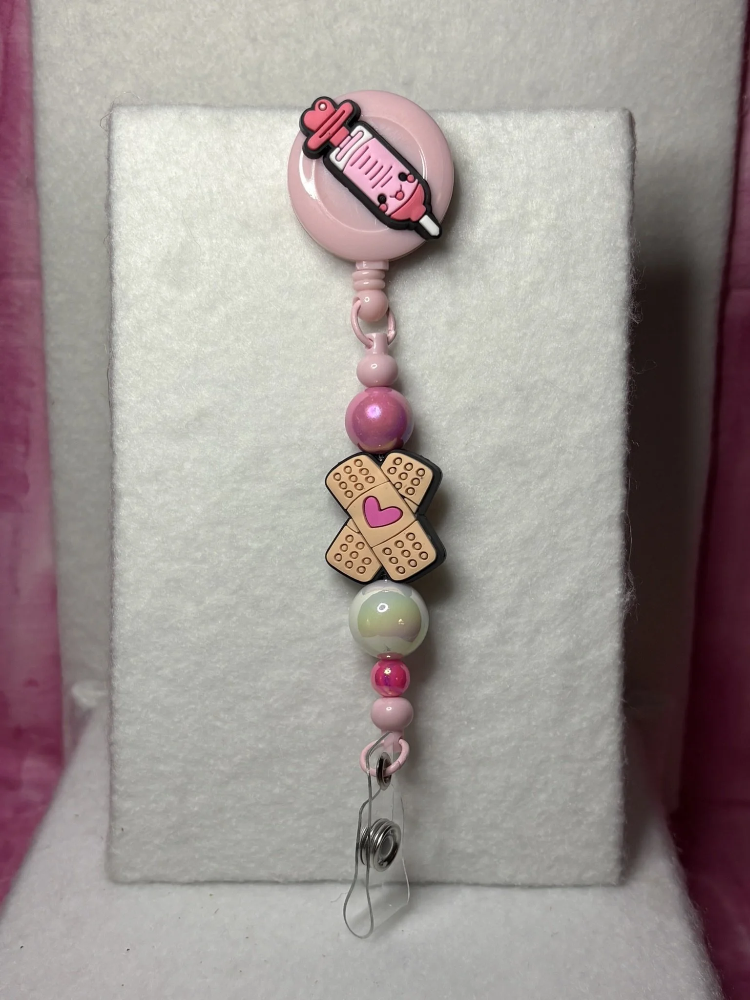 Pink Care & Comfort Badge Reel