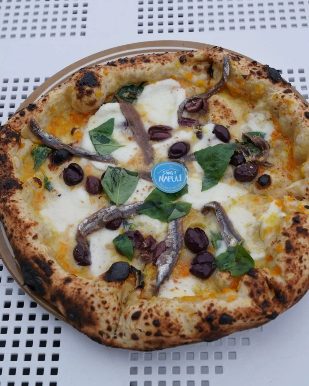 Special pizza served in a plate in outdoors table at our Rutherford Location