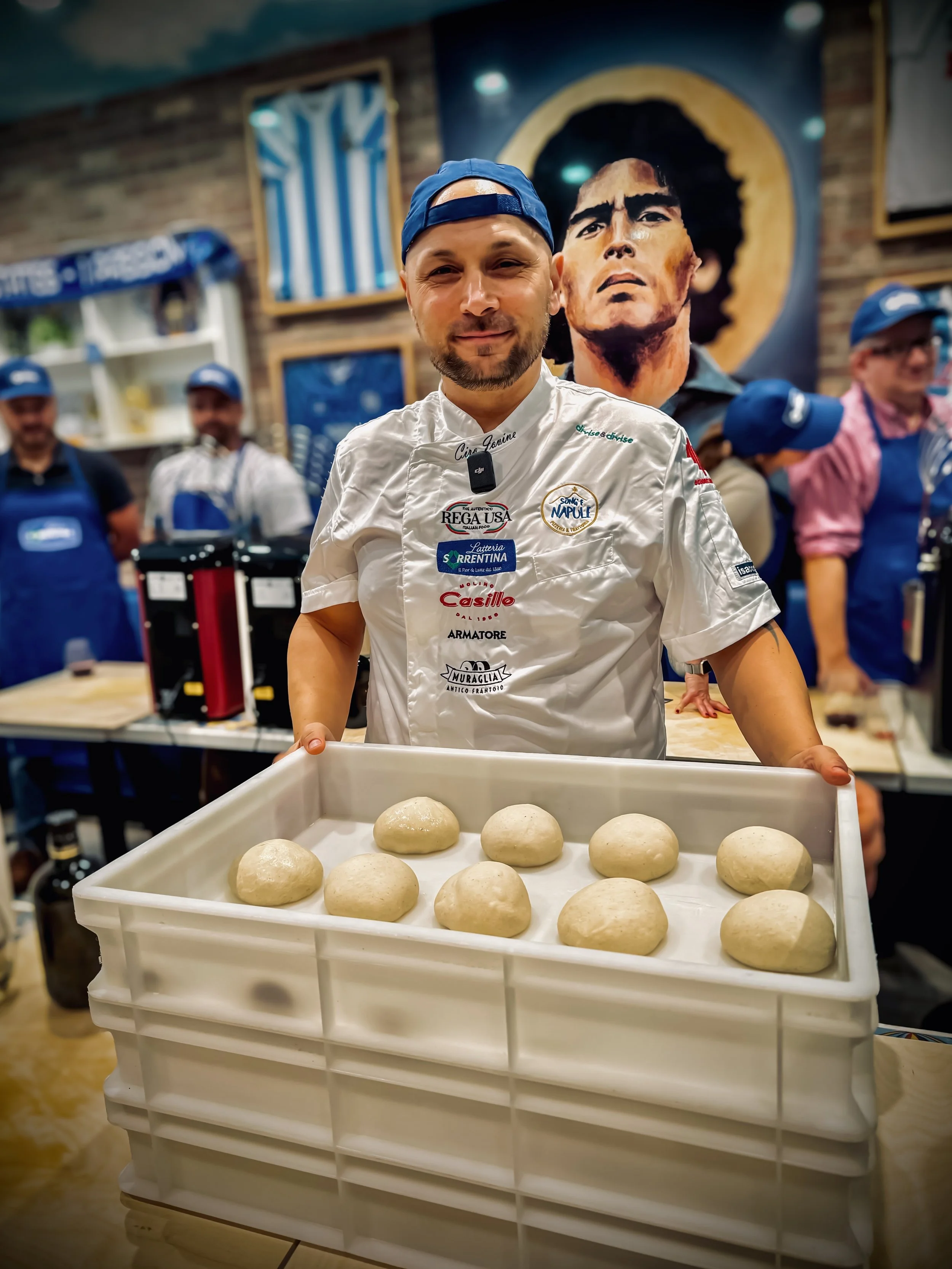 Ciro smiling presenting a case of fresh dough