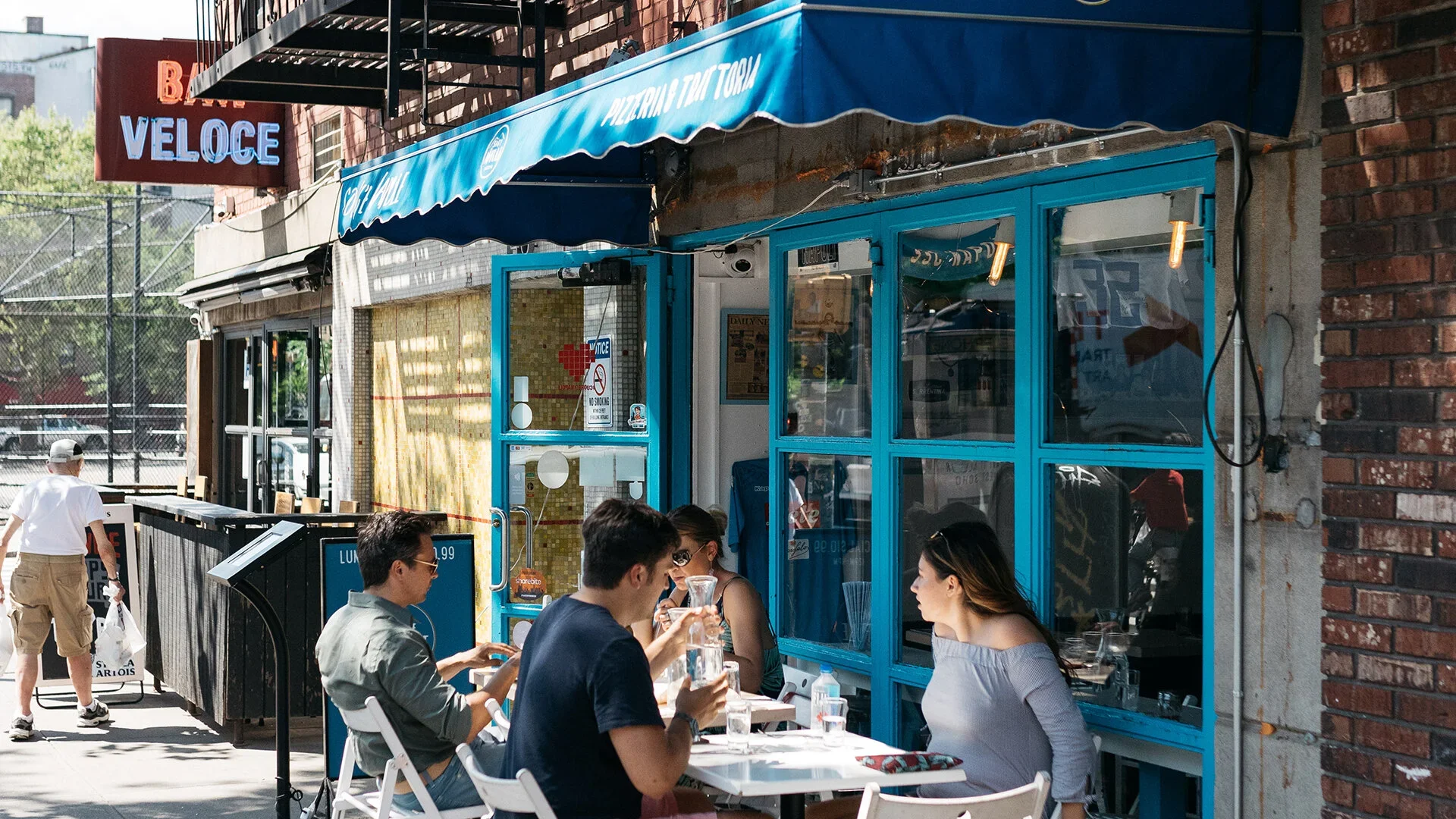 Guests dining outdoors at the first Song' e Napule location