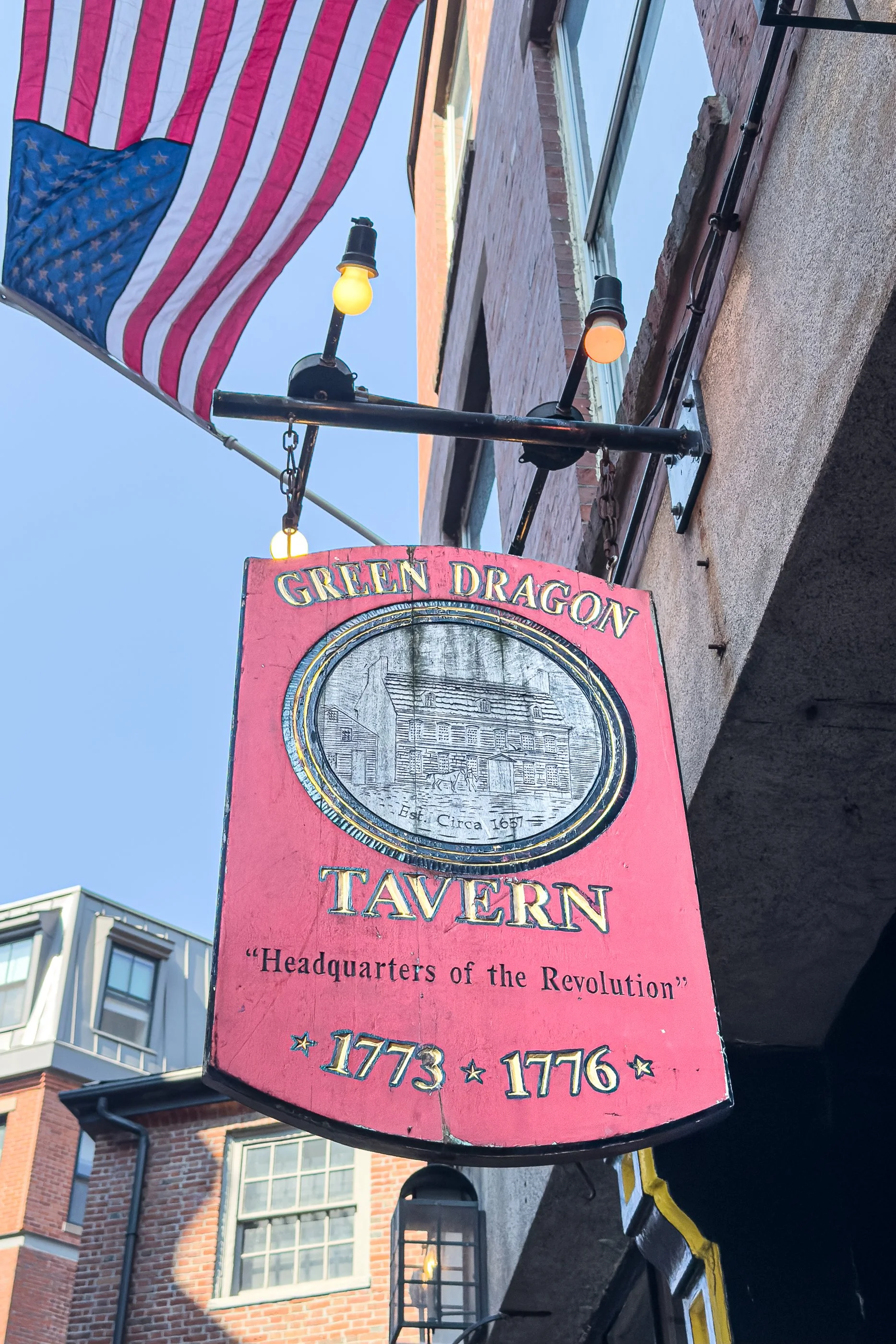 The Green Dragon Tavern sign hangs over Marshall Street in Boston’s North End. The original tavern stood nearby on Union Street, where the Sons of Liberty met to share intelligence and plan. The building is gone. The name survived.