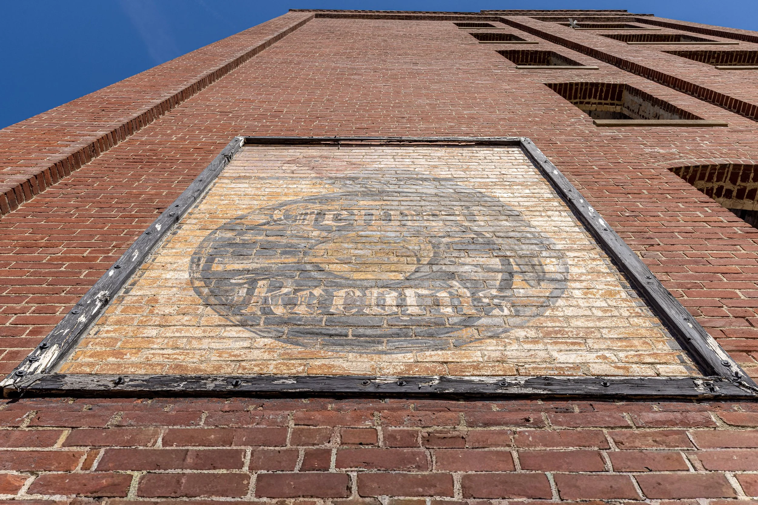 A faded Gennett Records logo still clings to the brick tower at the former Starr Piano grounds. The lettering is physical evidence that a company built around pianos and player pianos eventually entered the new world of recorded sound.