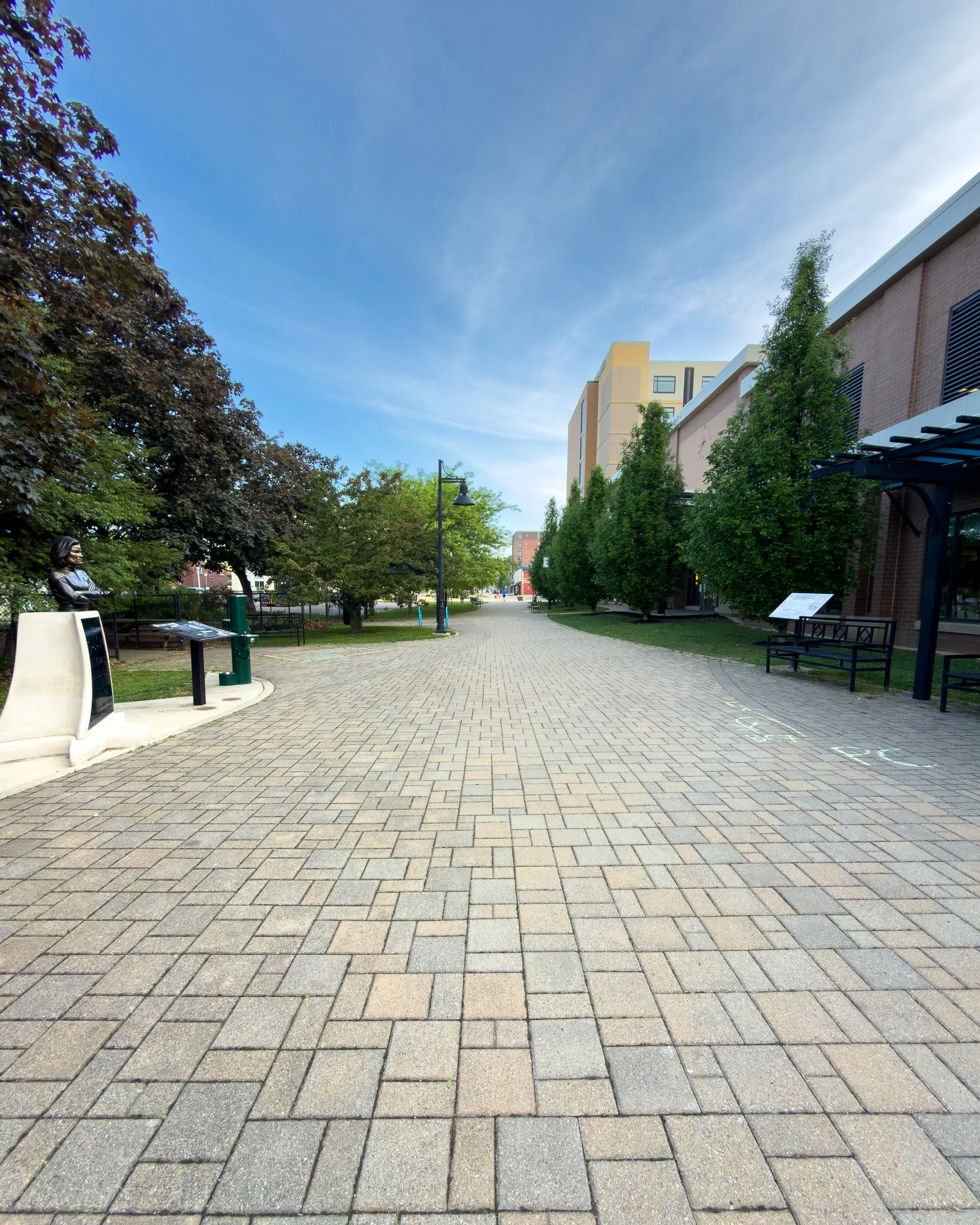 Wide view of the Captain Kathryn Janeway statue beside the B-Line in Bloomington Indiana near WonderLab science museum.