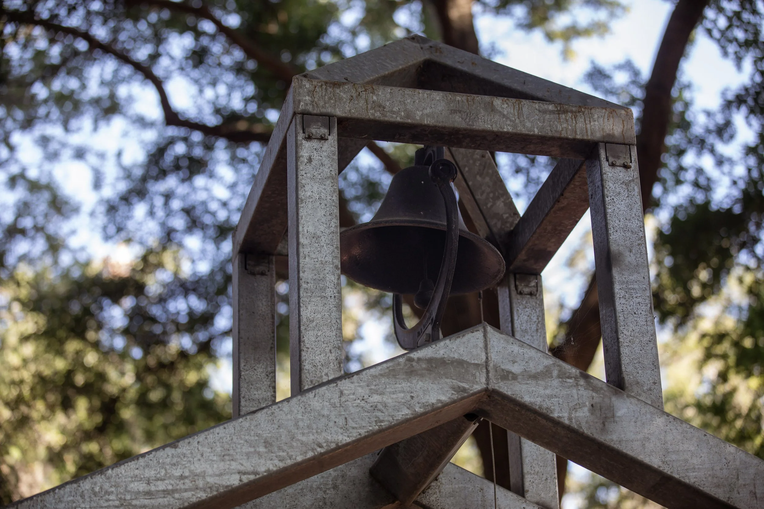 Bell tower of First African Baptist Church at Historic Mitchelville Freedom Park, surrounded by trees.