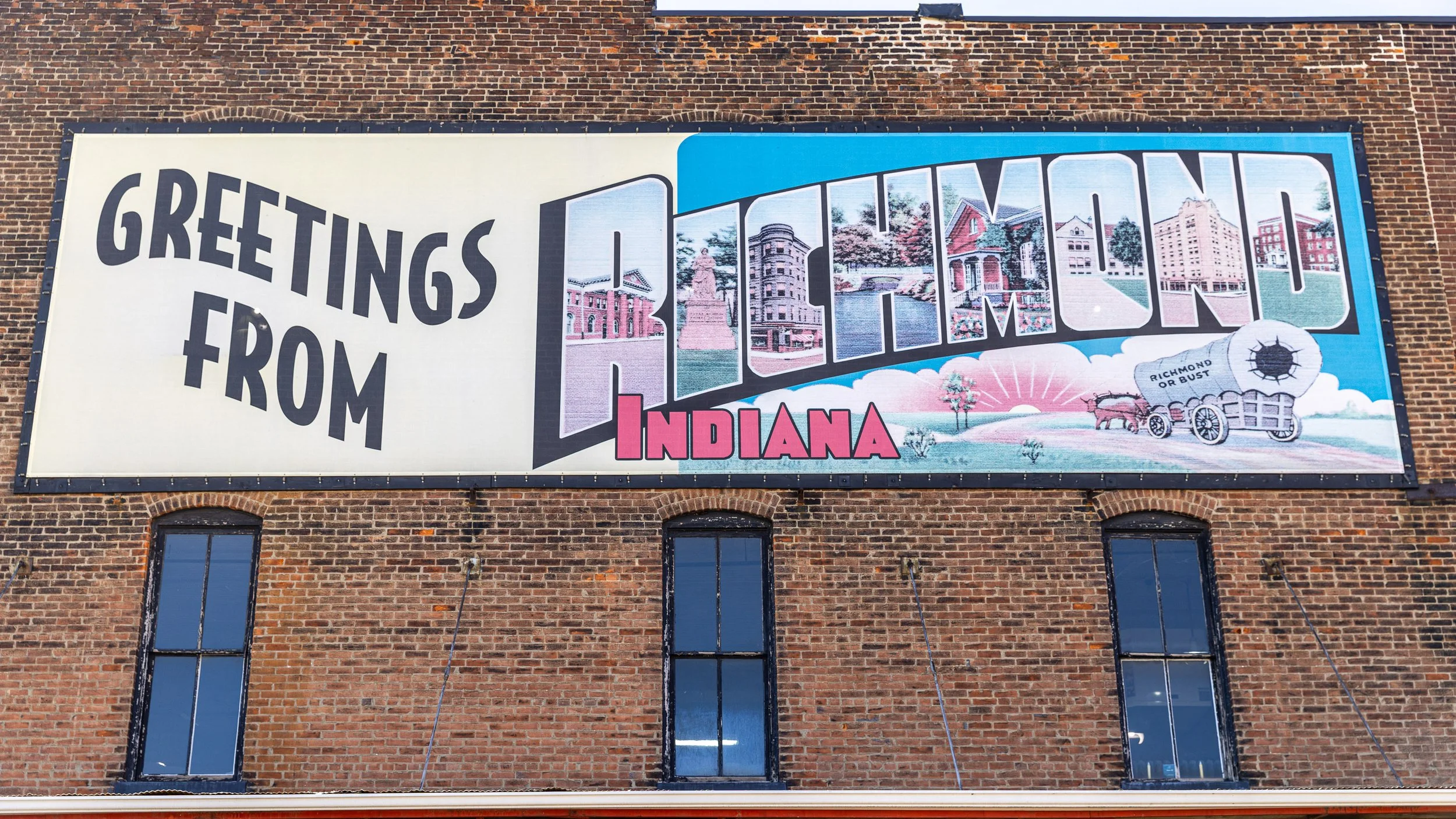 Richmond’s postcard-style mural fills each letter with landmarks drawn from around the city. Look closely and the cheerful greeting becomes a map of a place where industrial brick, civic memory, and an unexpected chapter of American music still overl