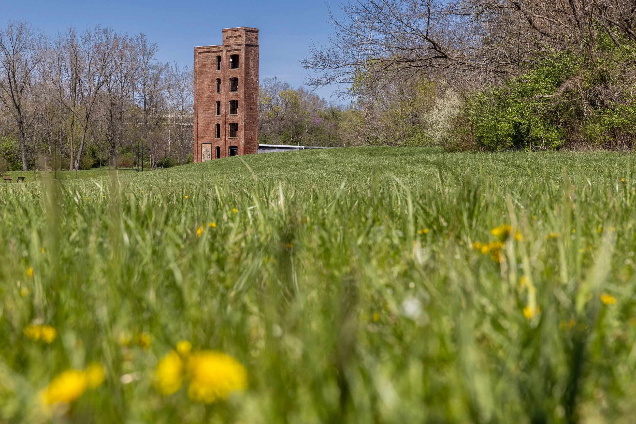 Wild grass and spring flowers now surround the surviving Starr Piano tower in Richmond. The peaceful landscape gives little hint that a thirty-five-acre industrial complex once filled this valley—or that music recorded here traveled far beyond it.