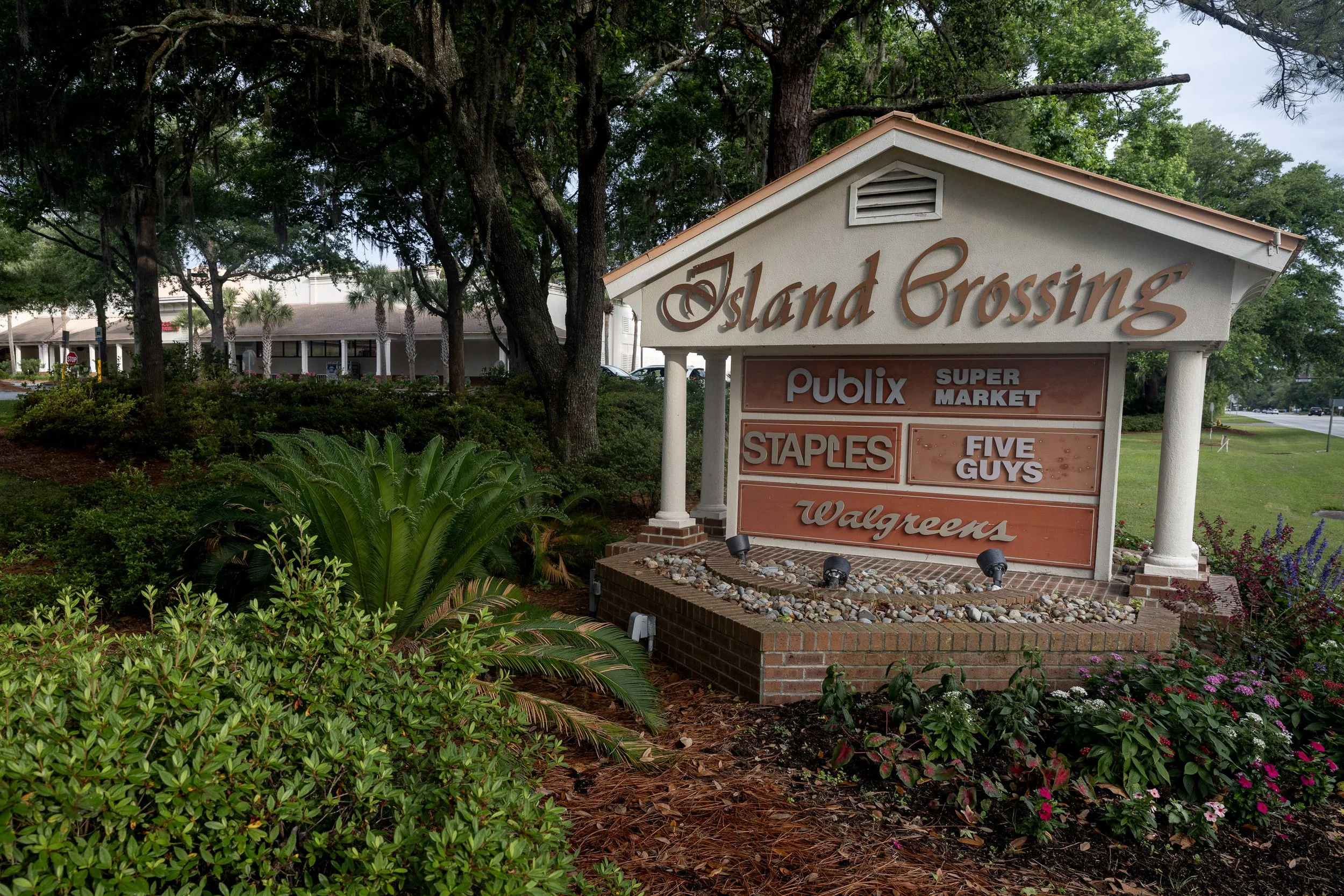 The entrance sign for Island Crossing sits low among trees and landscaping on Hilton Head Island. Here, wayfinding is designed to blend into the setting—one reason even busy commercial areas can seem to arrive only after you have nearly passed them.