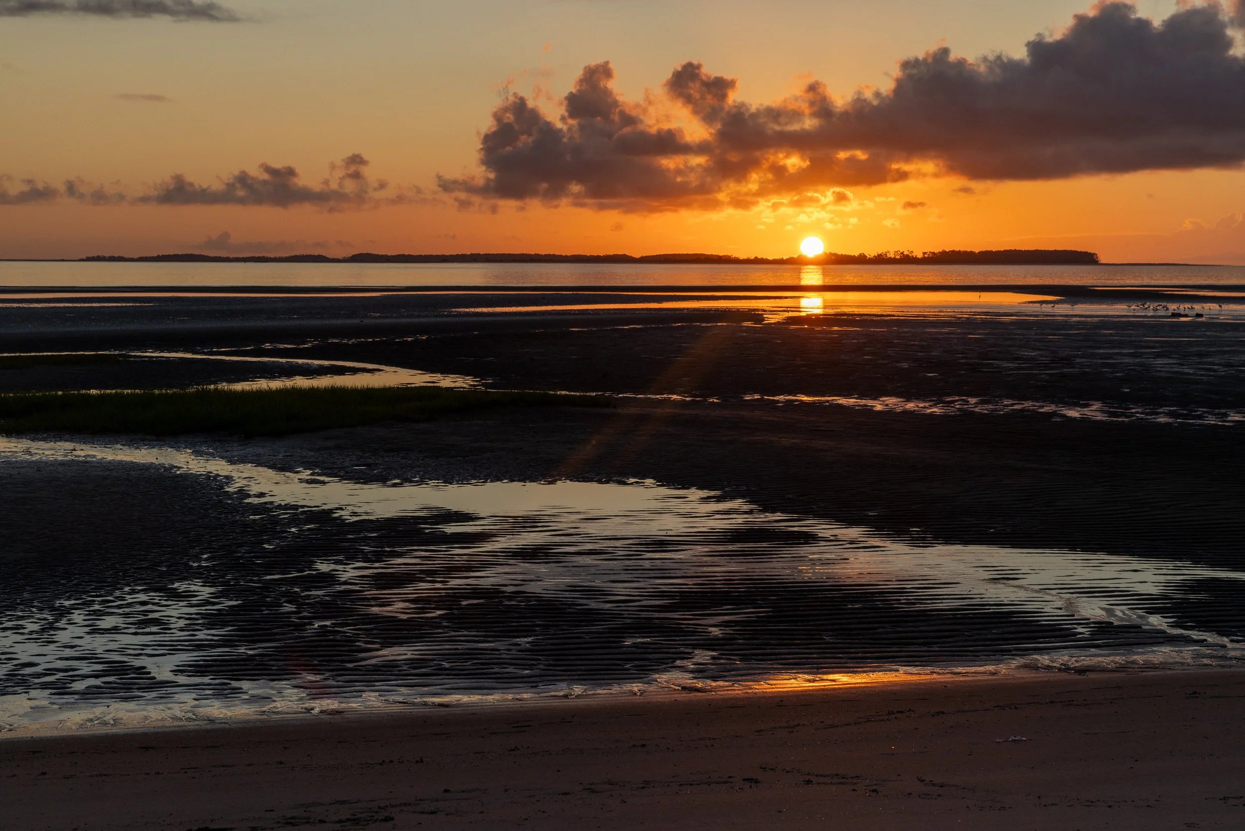 At sunrise, the tidal flats of Port Royal Sound catch the first light off Hilton Head Island. Beyond the horizon lies one of the South Atlantic coast’s deepest natural harbors—a quiet expanse whose geography has shaped centuries of movement and confl