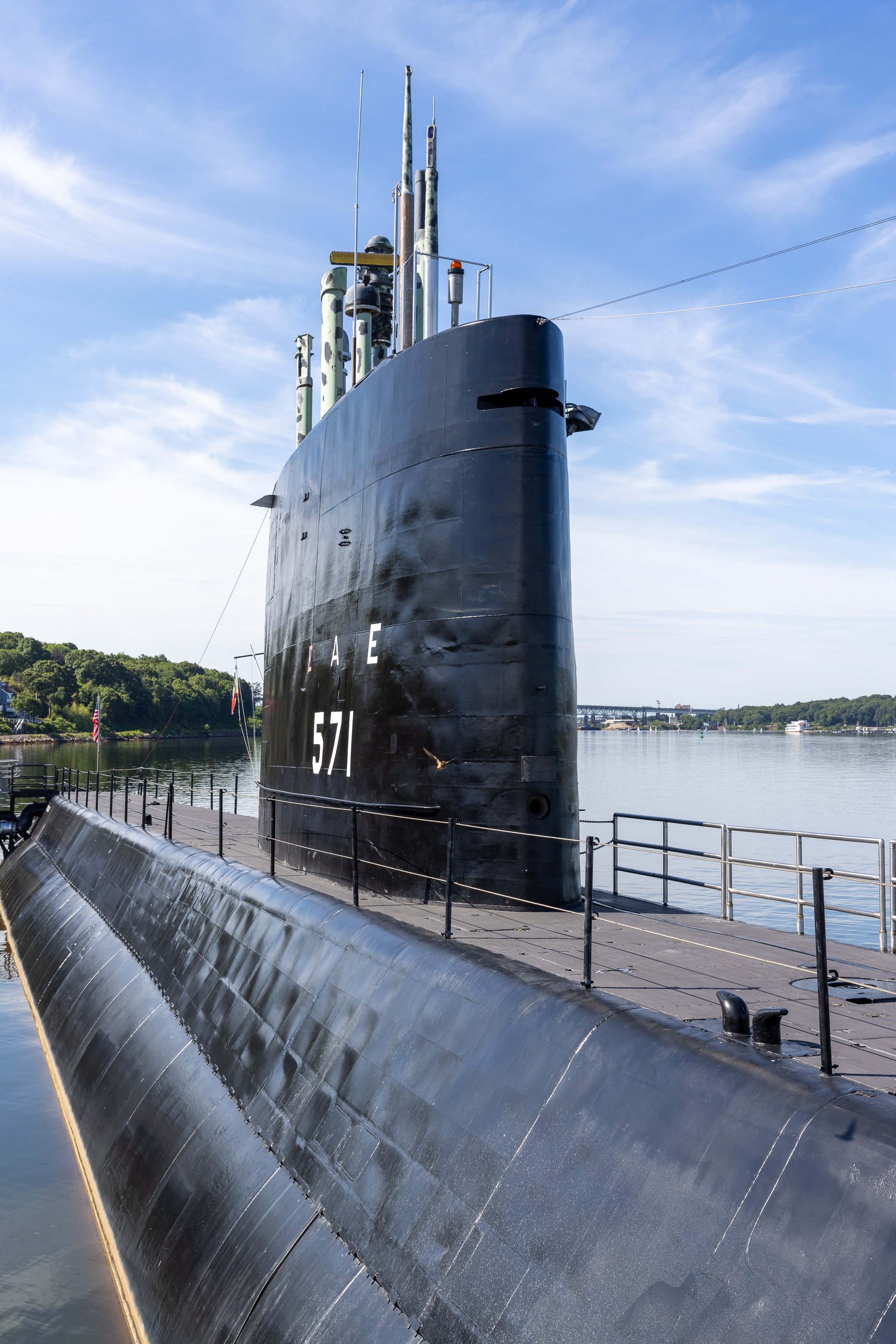 The black sail of USS Nautilus rises above her curved hull at the Submarine Force Museum in Groton. In 1954, the number 571 belonged to a vessel no navy had built before: the world’s first nuclear-powered submarine.