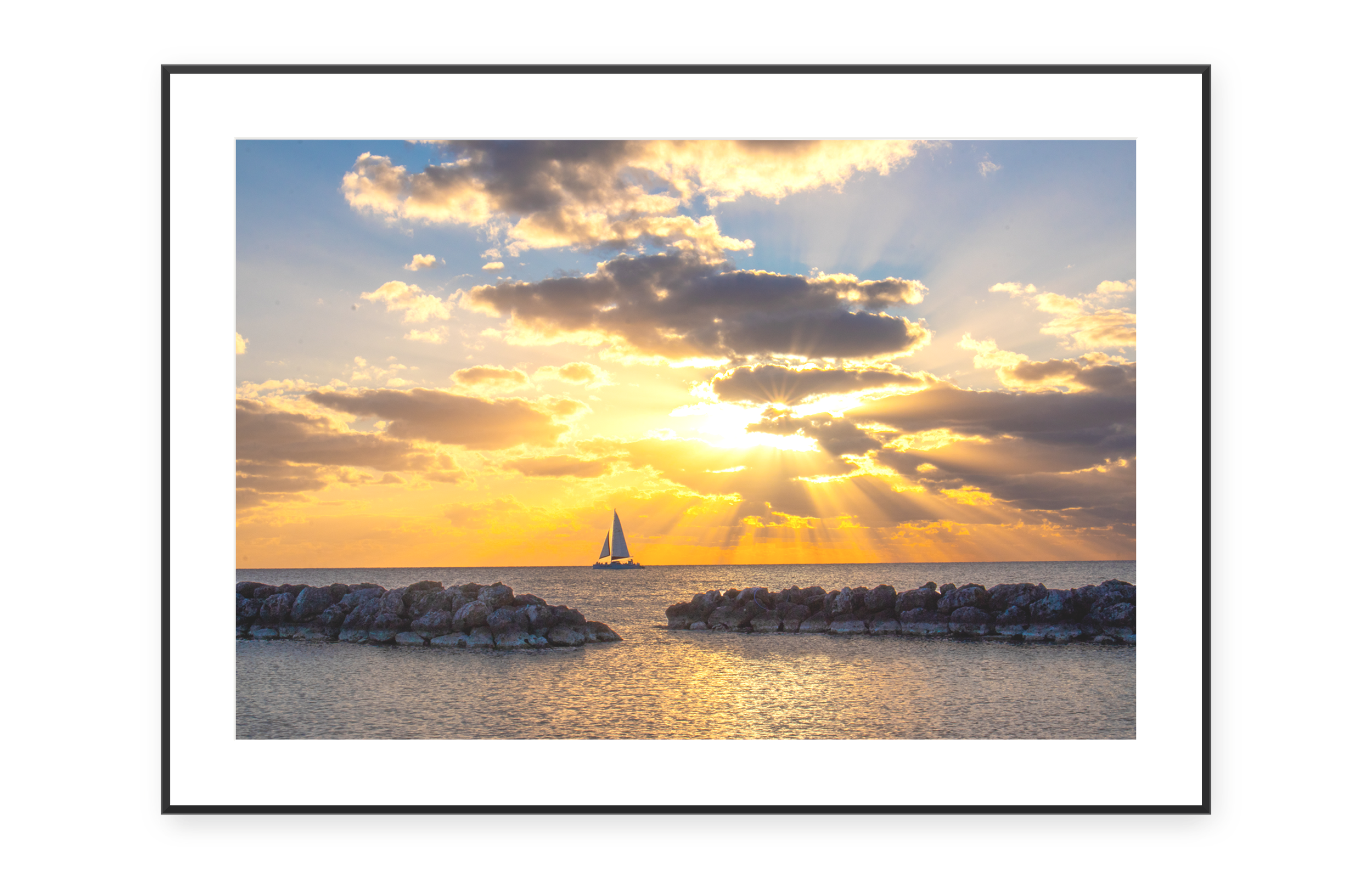 Framed photographic print of a sailboat at sunset off Hilton Head Island, South Carolina.