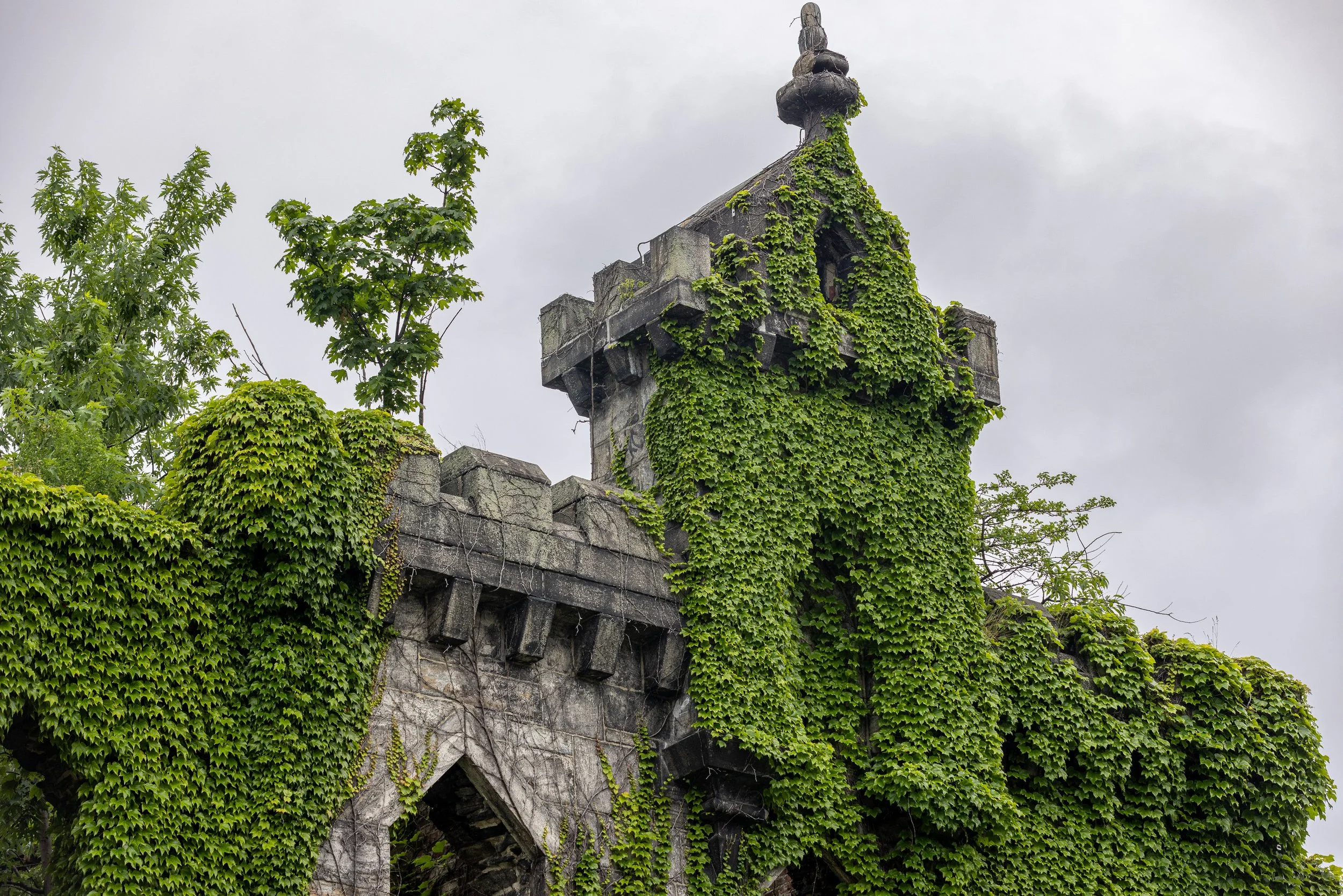 Ivy covers part of the roofless Smallpox Hospital ruin. The building has been empty for decades, but its surviving stone walls preserve a visible piece of the era when the island housed many of New York City’s institutions.