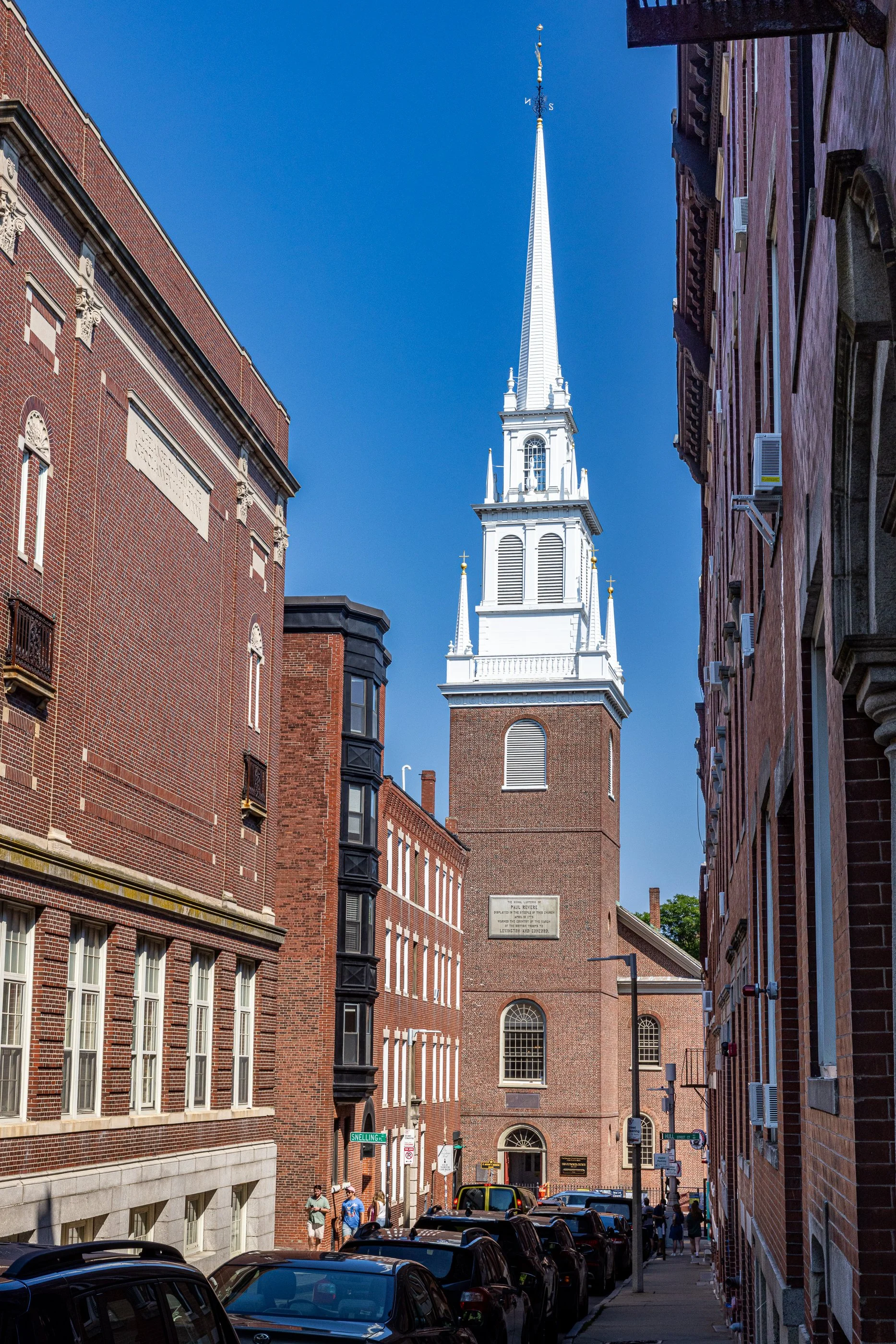 Old North Church stands at the end of Hull Street in Boston’s North End. In 1775, its steeple could be seen across the Charles River, making it a useful signal point for people waiting on the other side.