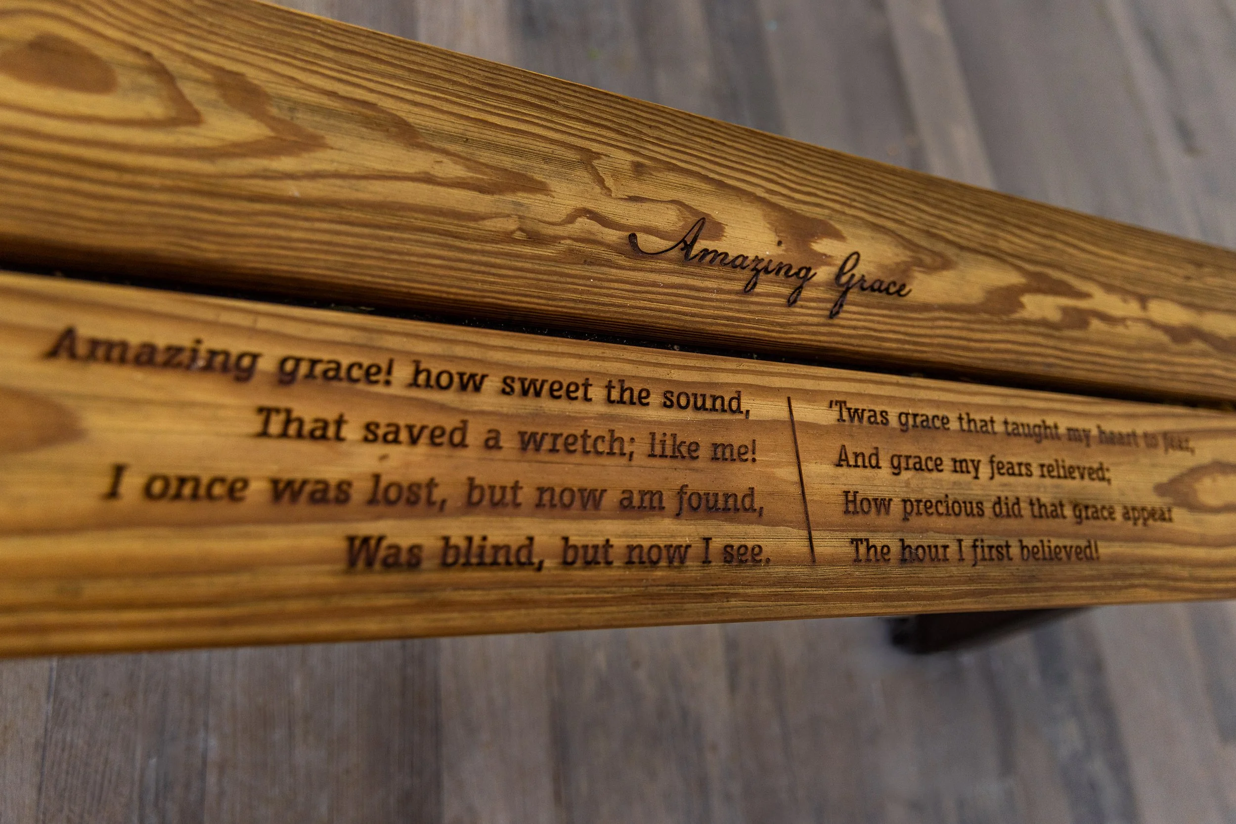 "Amazing Grace” is inscribed across a wooden bench in the church at Historic Mitchelville Freedom Park. John Newton, who wrote the words in 1772, had commanded ships carrying enslaved Africans before becoming a minister and, decades later, publicly c