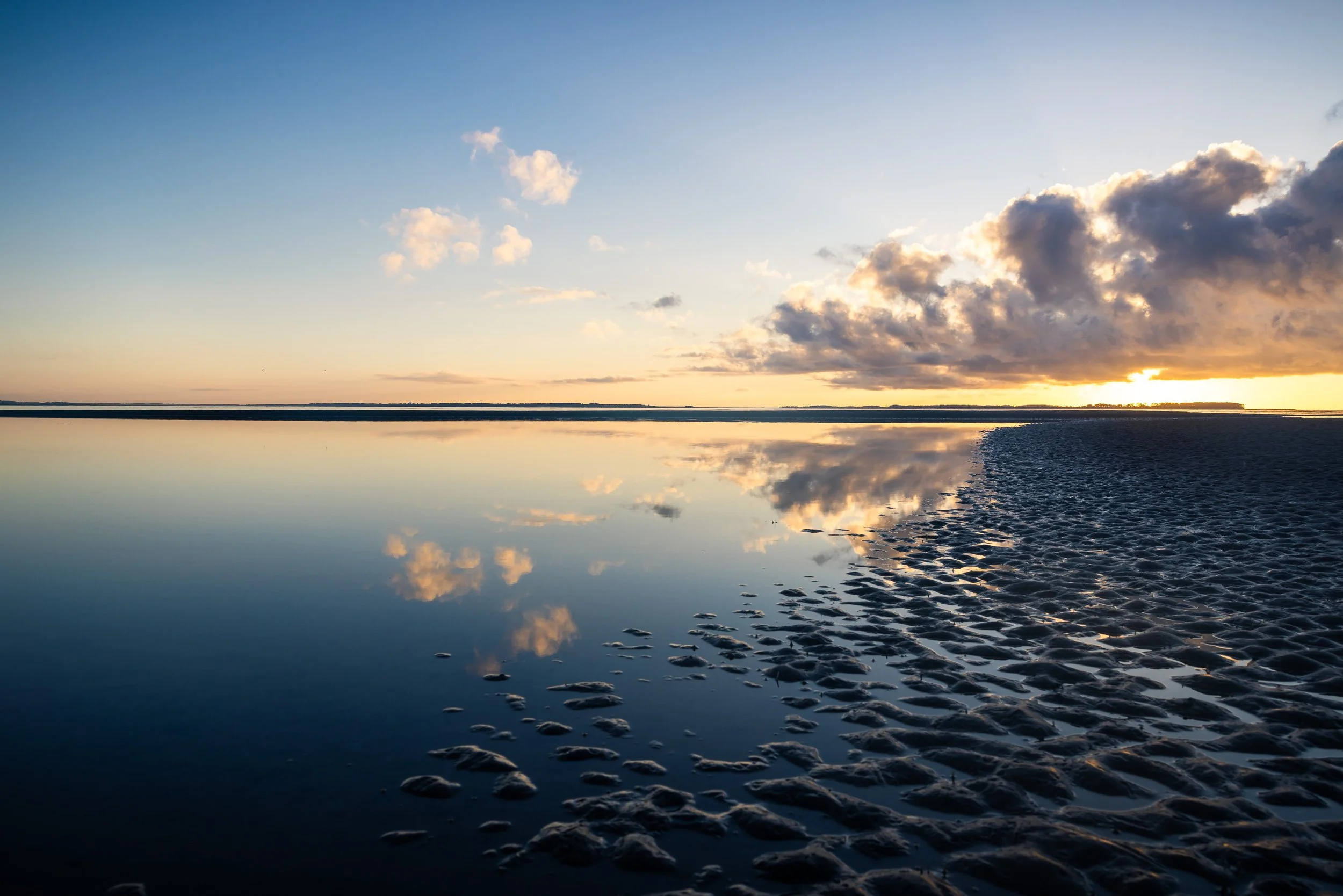 Before sunrise, shallow water turns the flats of Port Royal Sound into a near-perfect mirror. Hilton Head’s six-to-eight-foot tides redraw this shoreline twice each day, replacing open water with rippled sand and back again.
