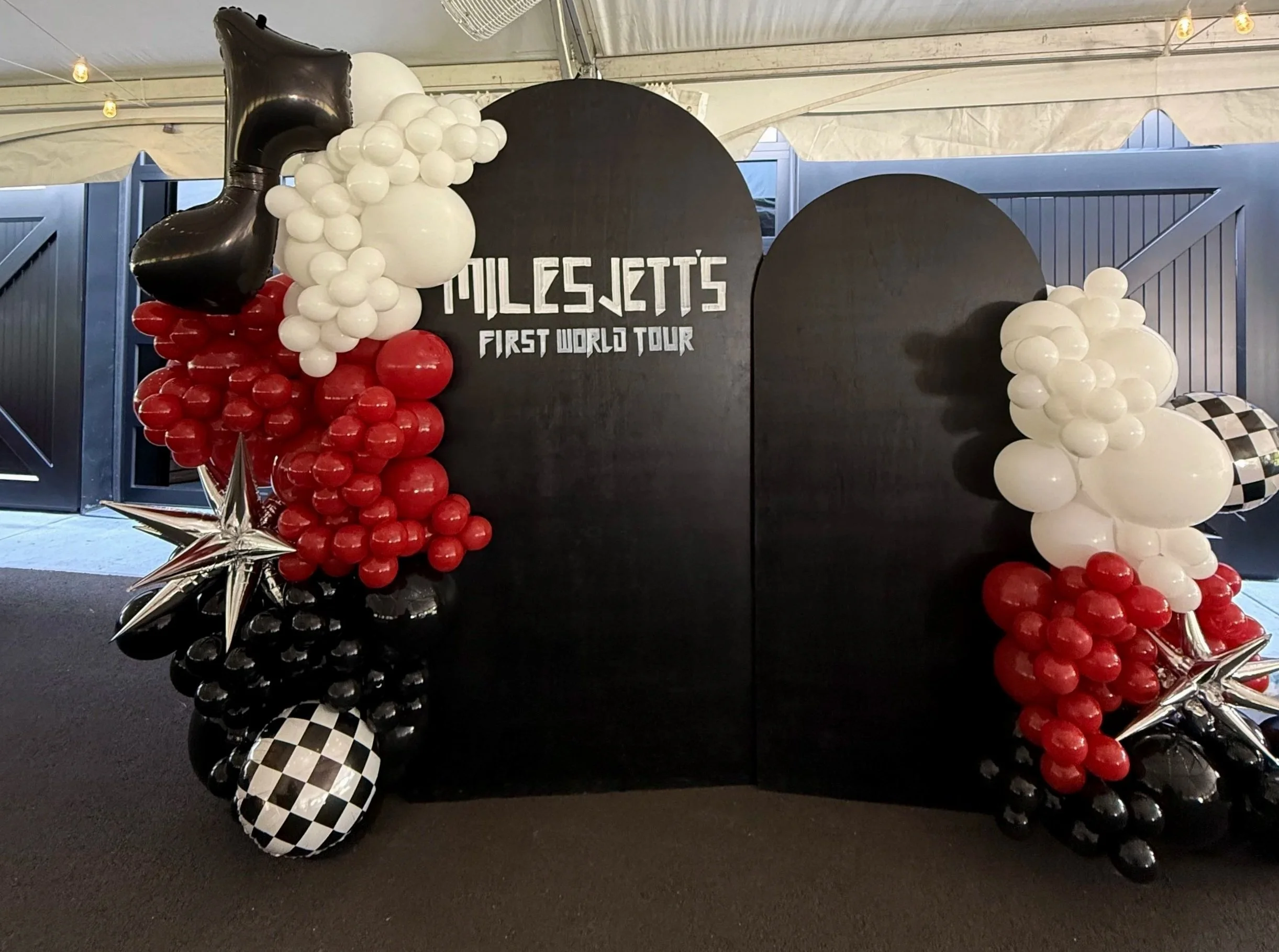 Custom balloon backdrop for a first birthday themed 'Miles Jett's First World Tour' by Wildly Pretty Events