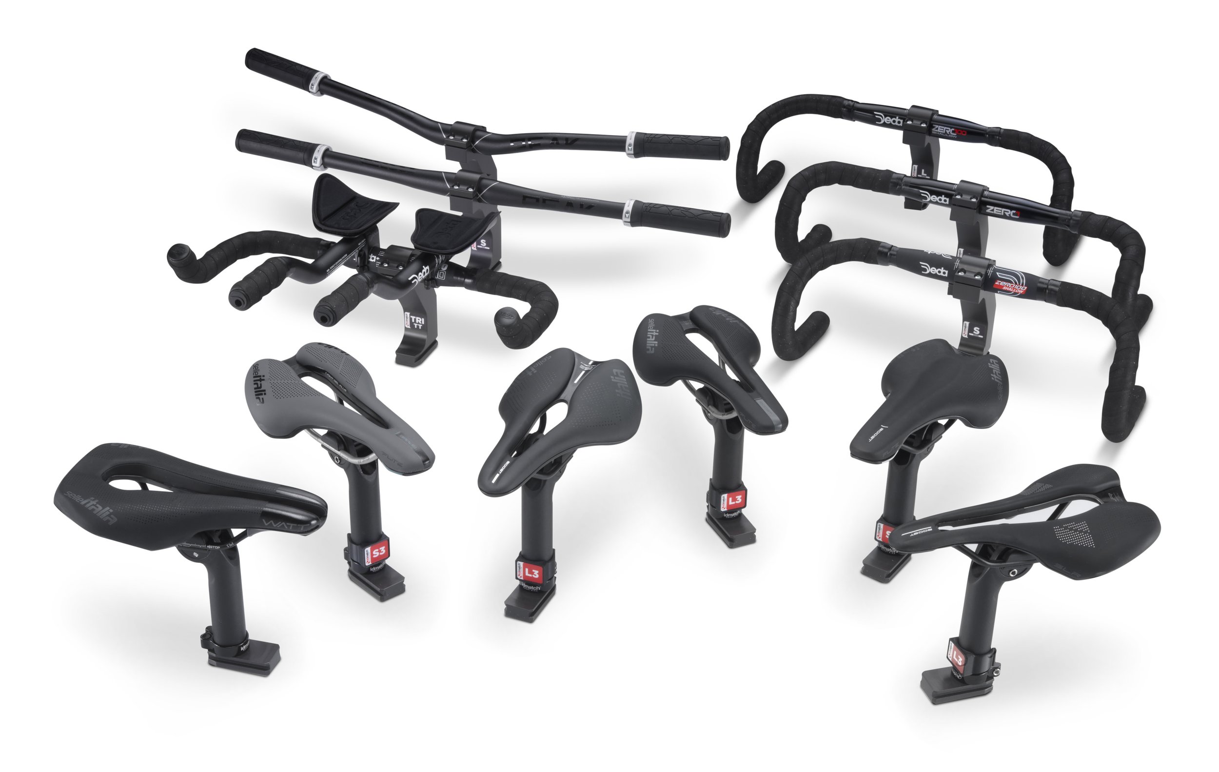 Multiple black bicycle saddles and bike handlebars arranged on a white background.