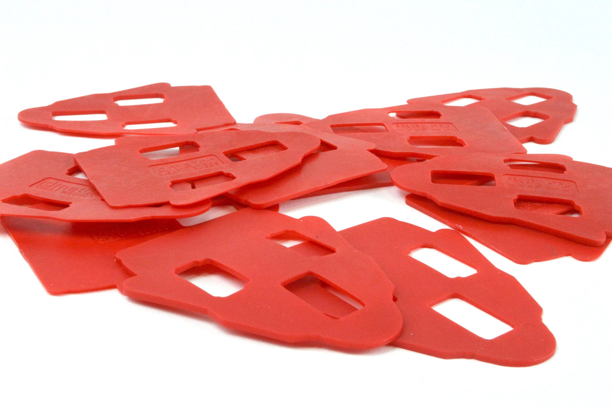 A pile of red plastic window lock replicas.