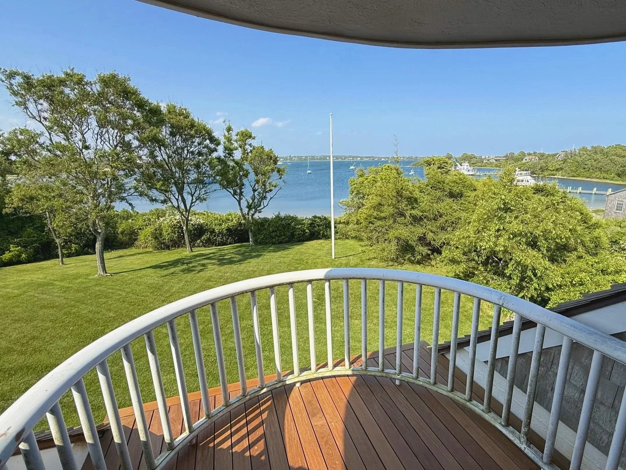Ipe narrow board deck balcony on an Owen's Corning OC Lumber frame with custom curved mahogany hand rails on Block Island RI