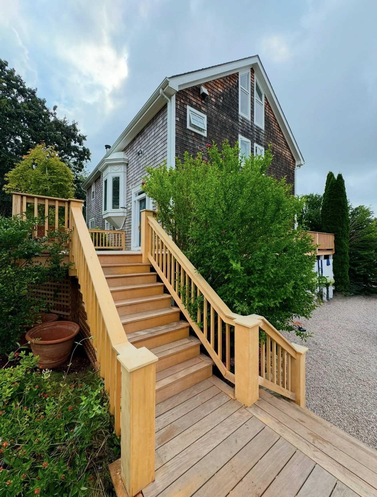 Garapa exotic tropical hardwood stairs with custom Alaskan Yellow Cedar rails in Watch Hill RI 