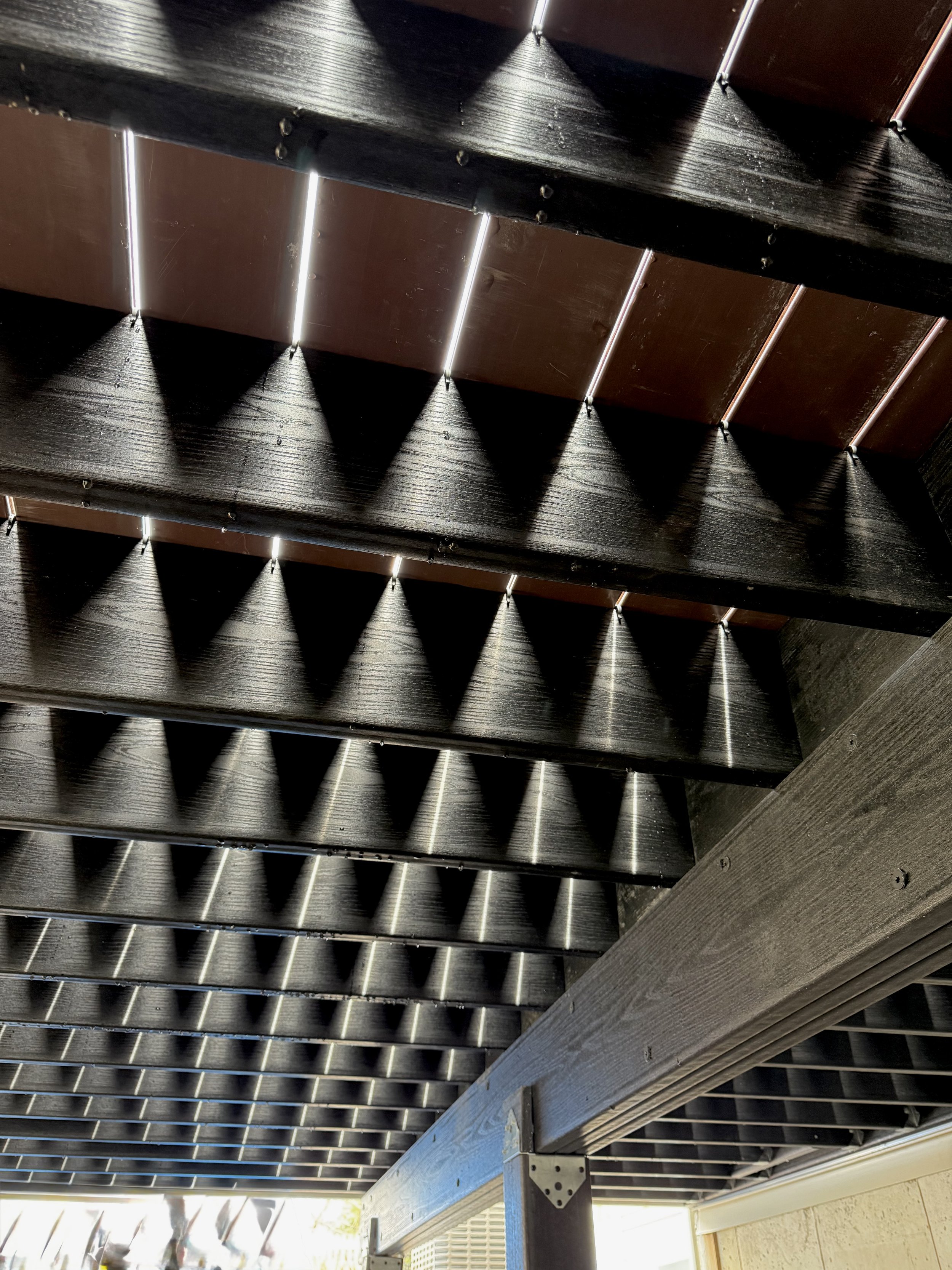 Owen's Corning OC Lumber modern framing in black seen from below on deck in Westerly RI