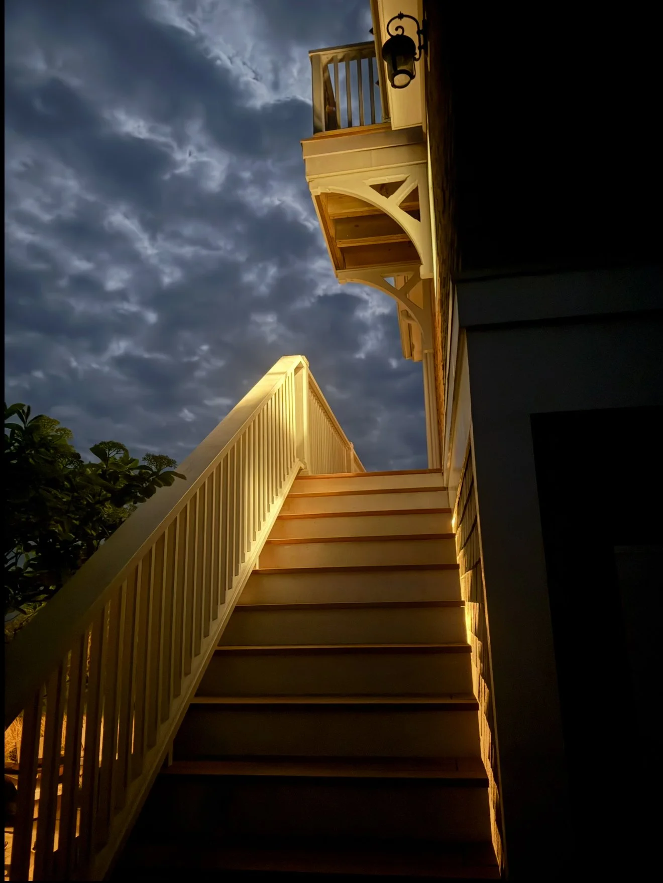 Custom mahogany stairs with paint grade western red cedar rails with mahogany balusters southern Block Island Seacliffs bluffs at night 