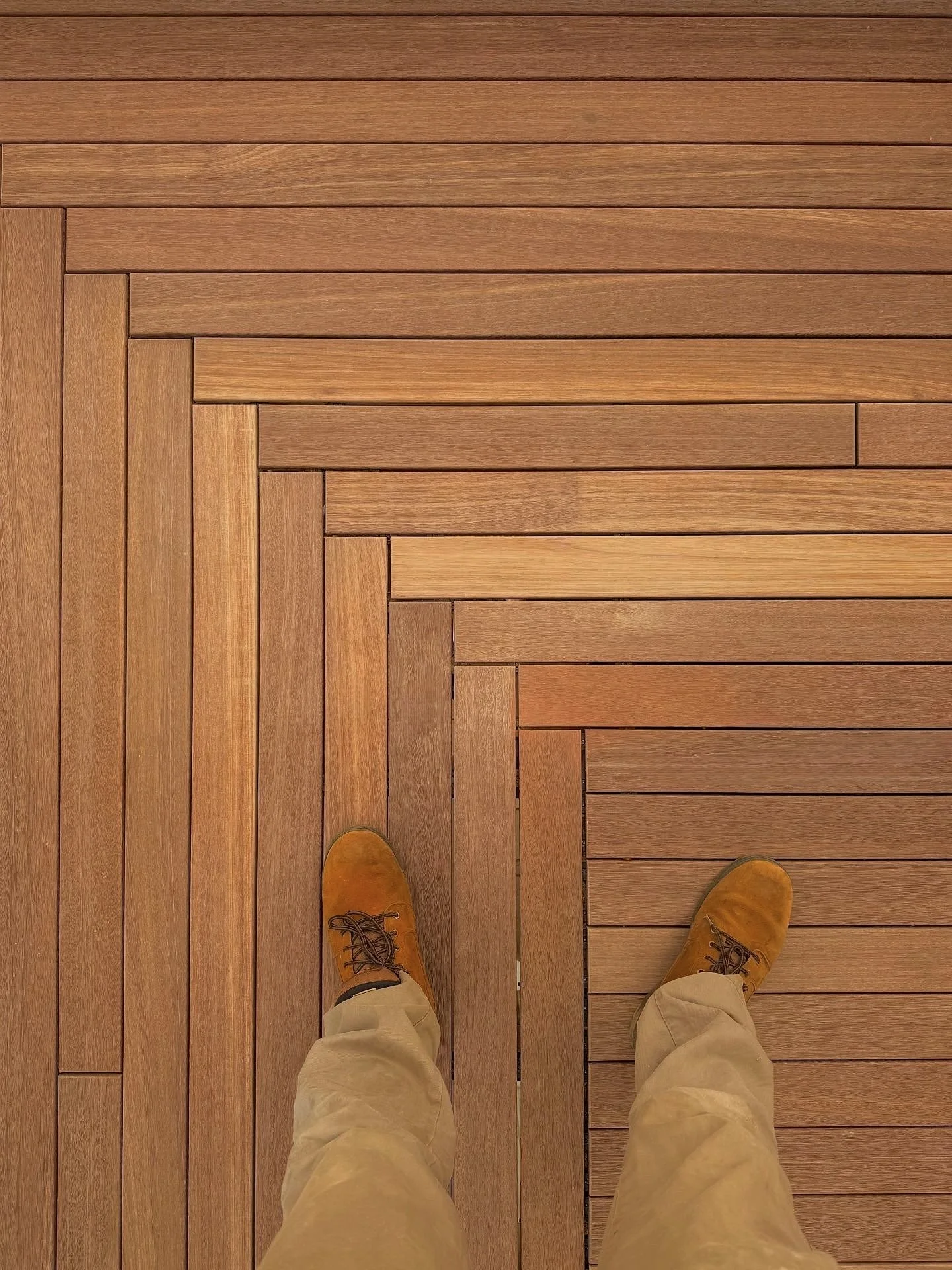 Custom mahogany herringbone deck corner with hidden clips on Block Island RI Southern Mohegan bluffs 