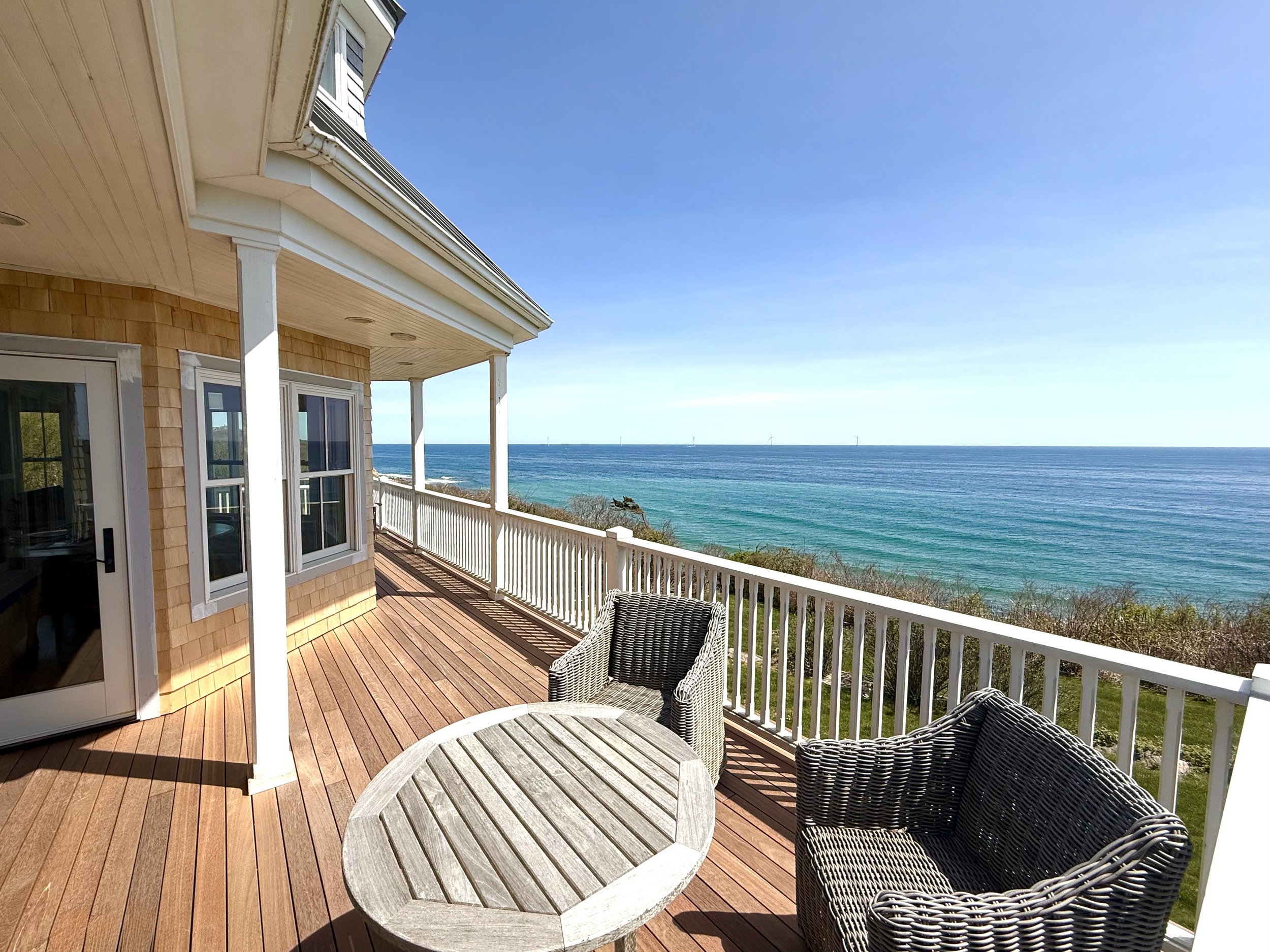 Block Island sea cliff deck made from hidden clip mahogany boards with paint grade custom cedar railings