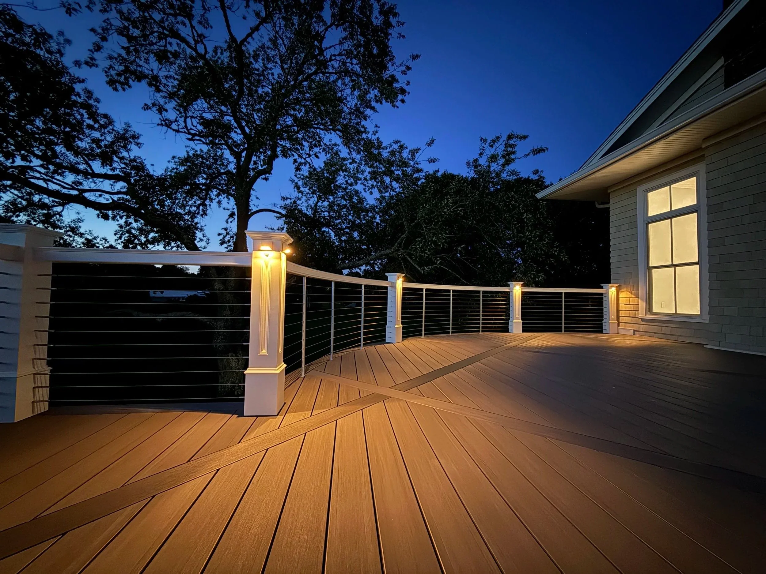 Timbertech Coastline vintage collection deck with diagonal diamond breaker boards, custom curved rails, and in-lite mini wedge lights in Watch Hill RI