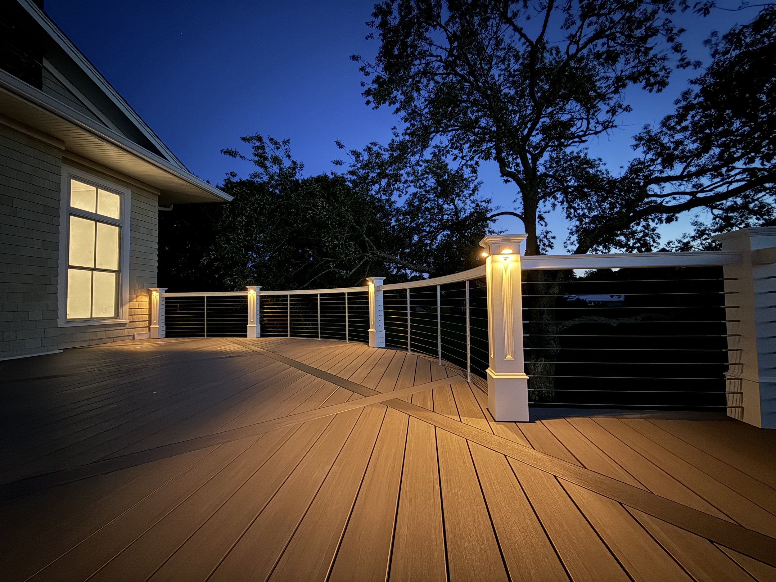 Custom bent radius curved deck with custom curved railings and diagonal breaker boards in Timber Tech vintage collection coastline in Watch Hill Rhode Island 