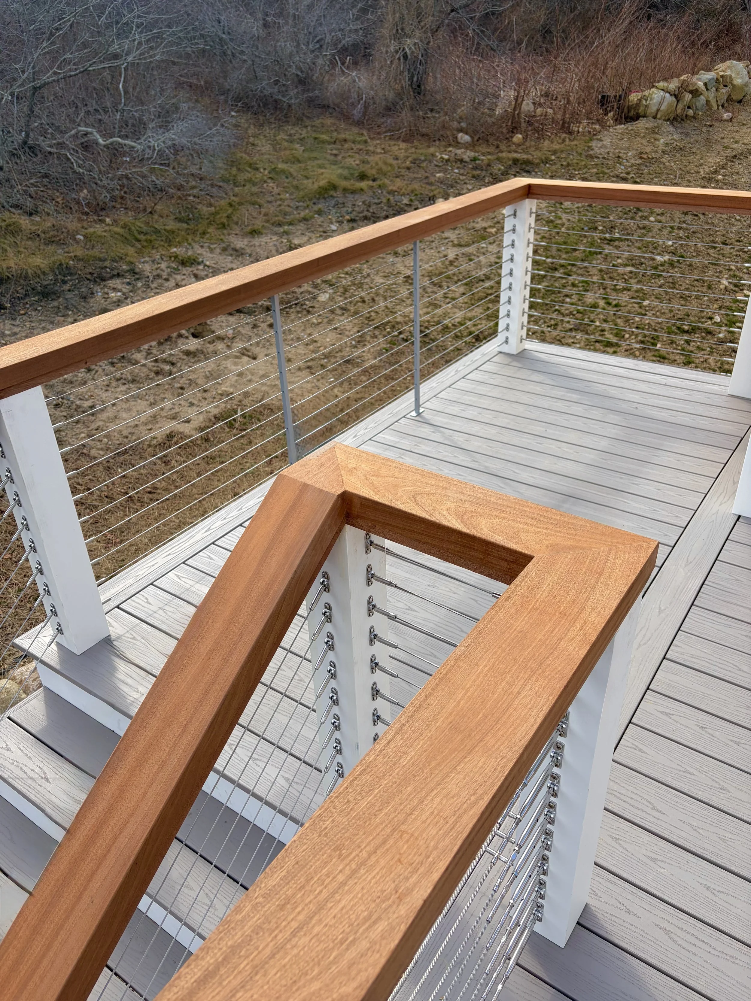 Custom 2x6 Mahogany and Sapele drink rails on Timber Tech Harvest Collection Slate Gray and Feeney cable railings on Block Island RI