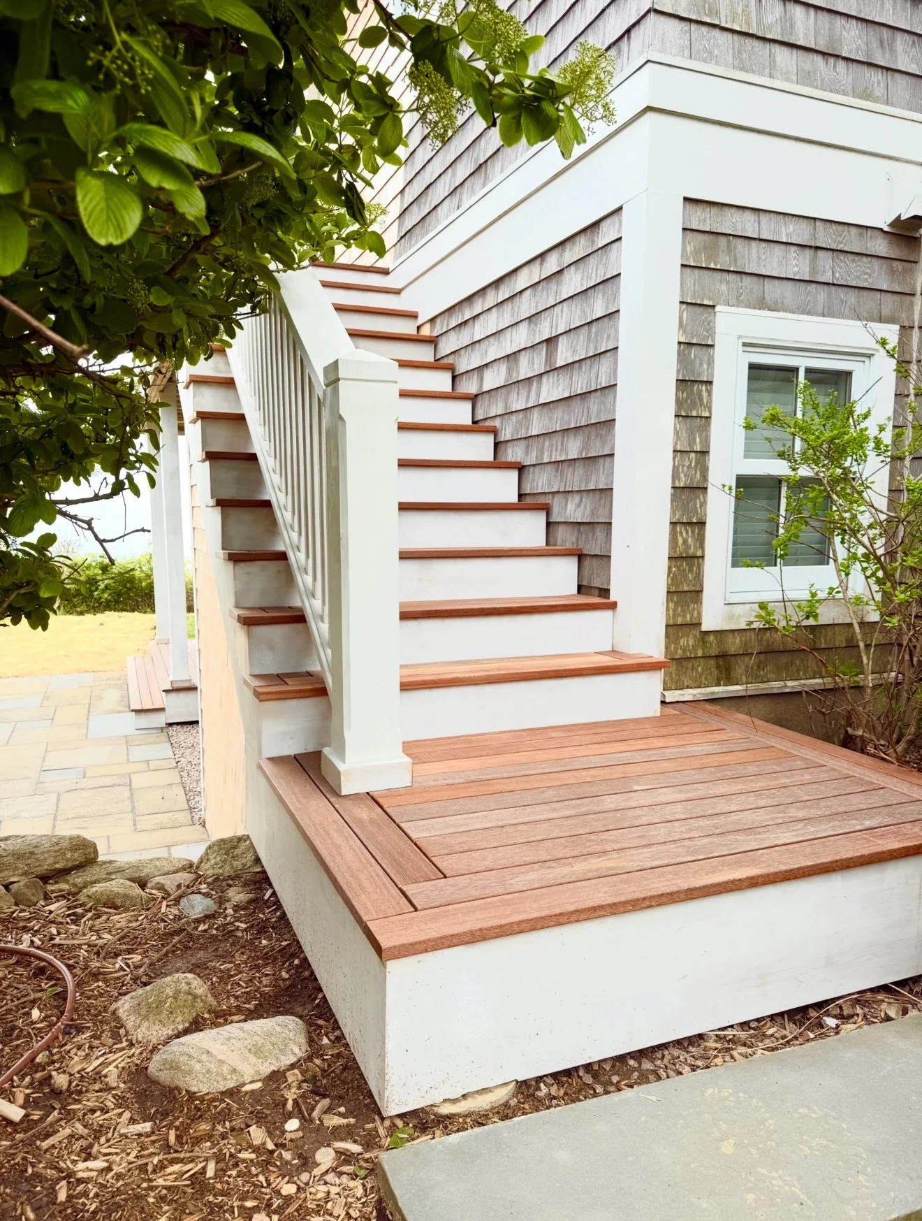 Custom mahogany and cedar staircase from a deck with herringbone pattern on Block Island RI