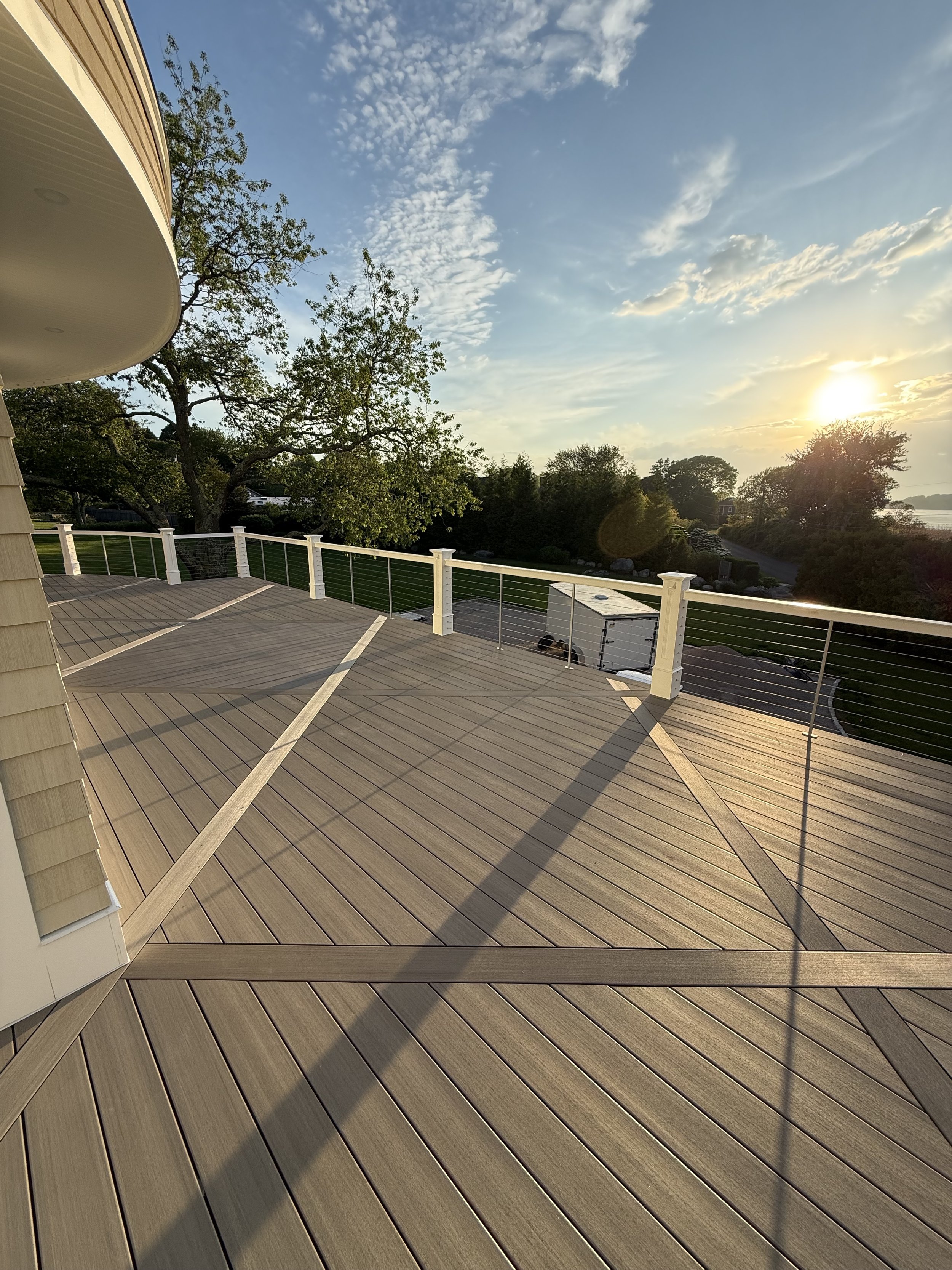 Timbertech Coastline vintage collection deck with diagonal diamond breaker boards, custom curved rails, and In-Lite Mini Wedge lights in Watch Hill RI